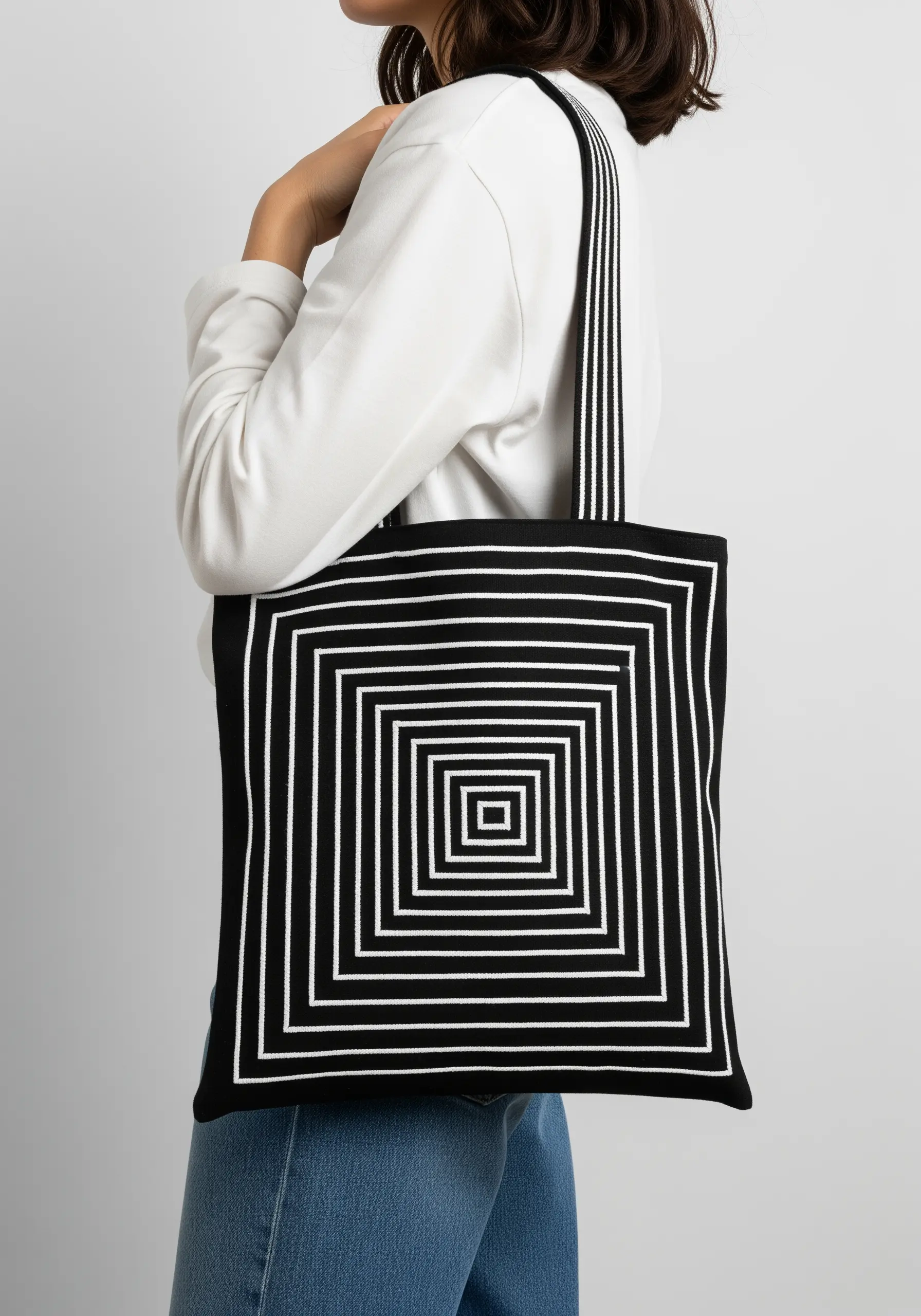 A geometric optical illusion of concentric squares embroidered in white on black