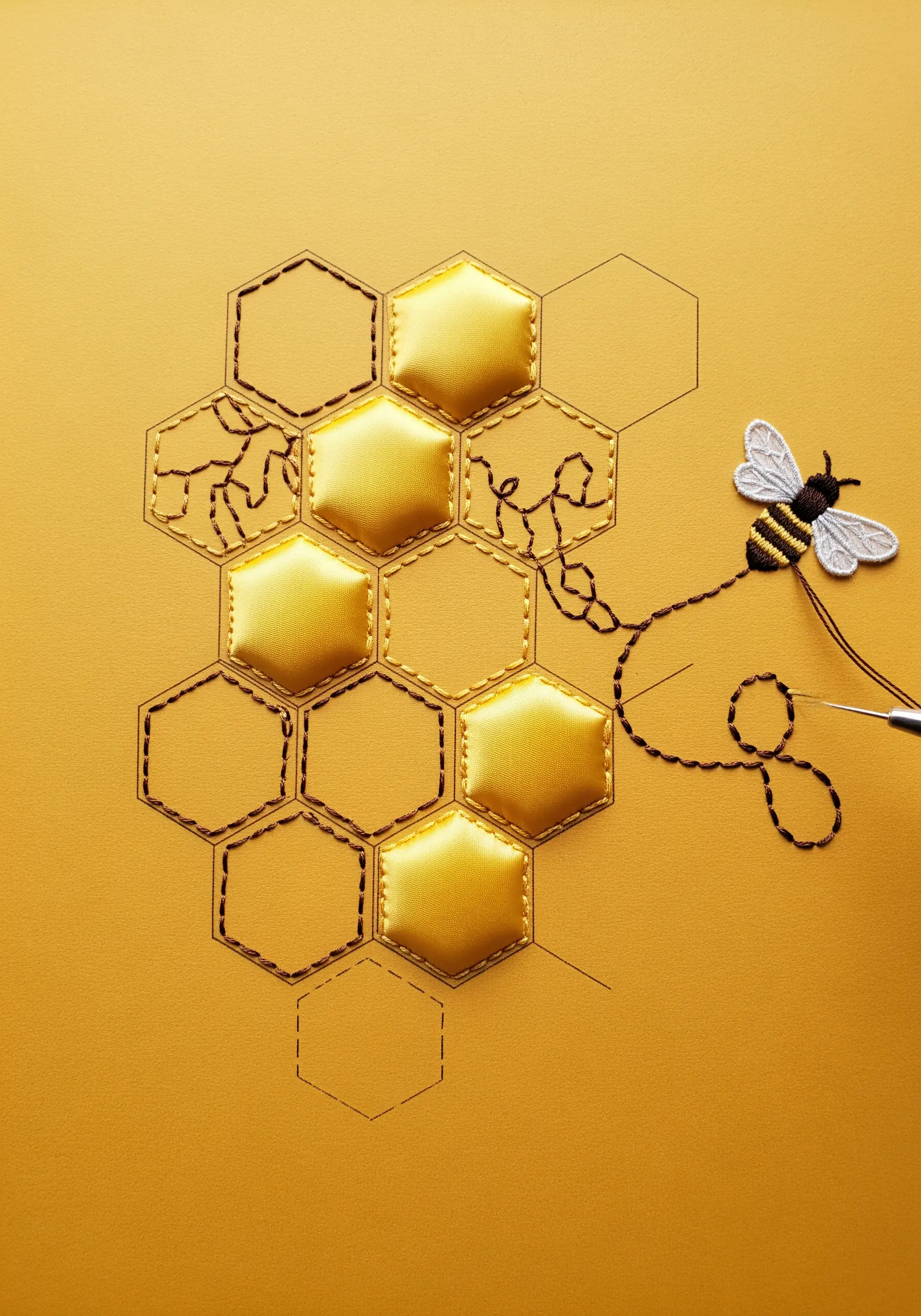 A honeycomb design with some cells created from padded yellow satin fabric.