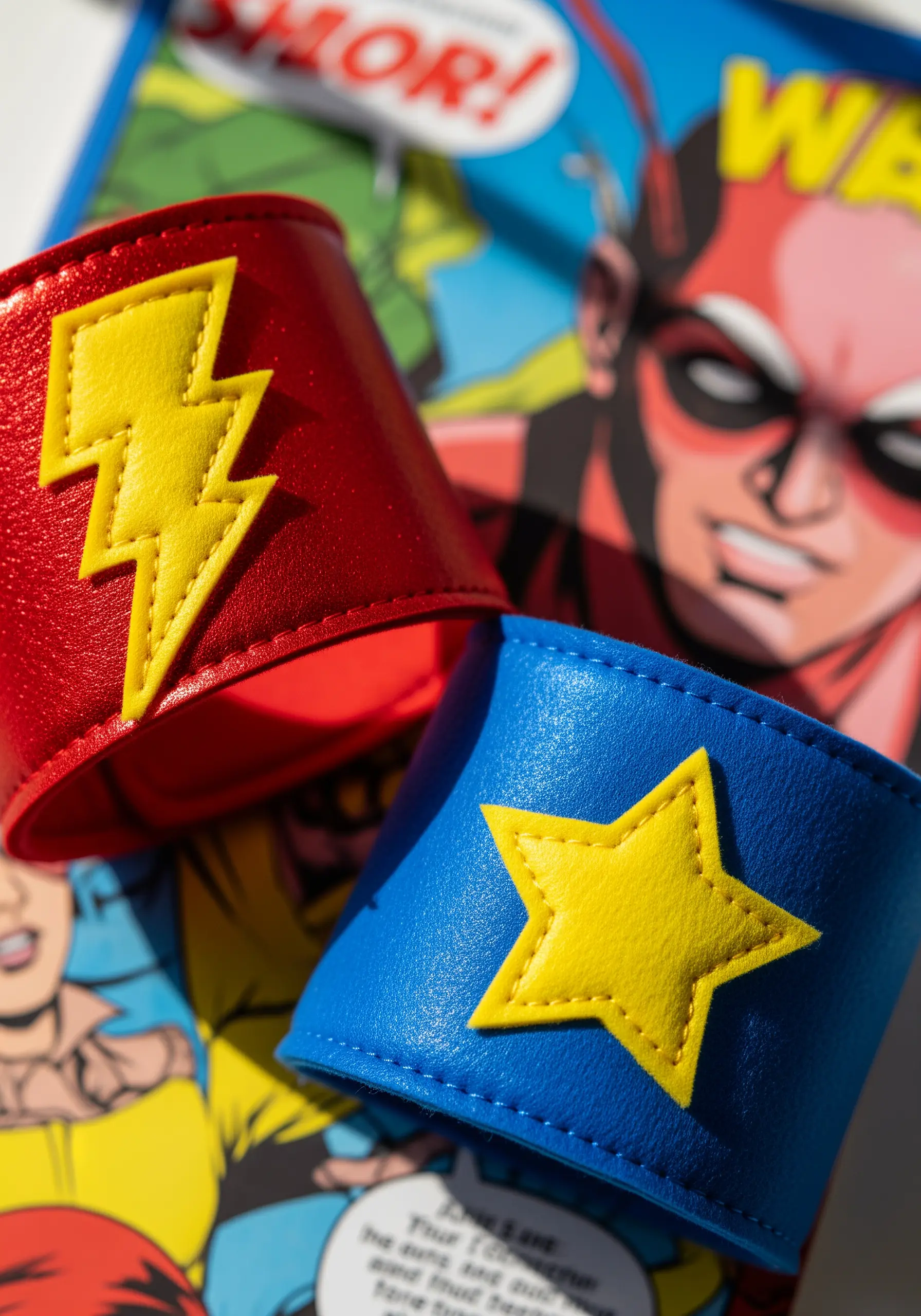 Red and blue faux leather superhero cuffs with a yellow lightning bolt and star.