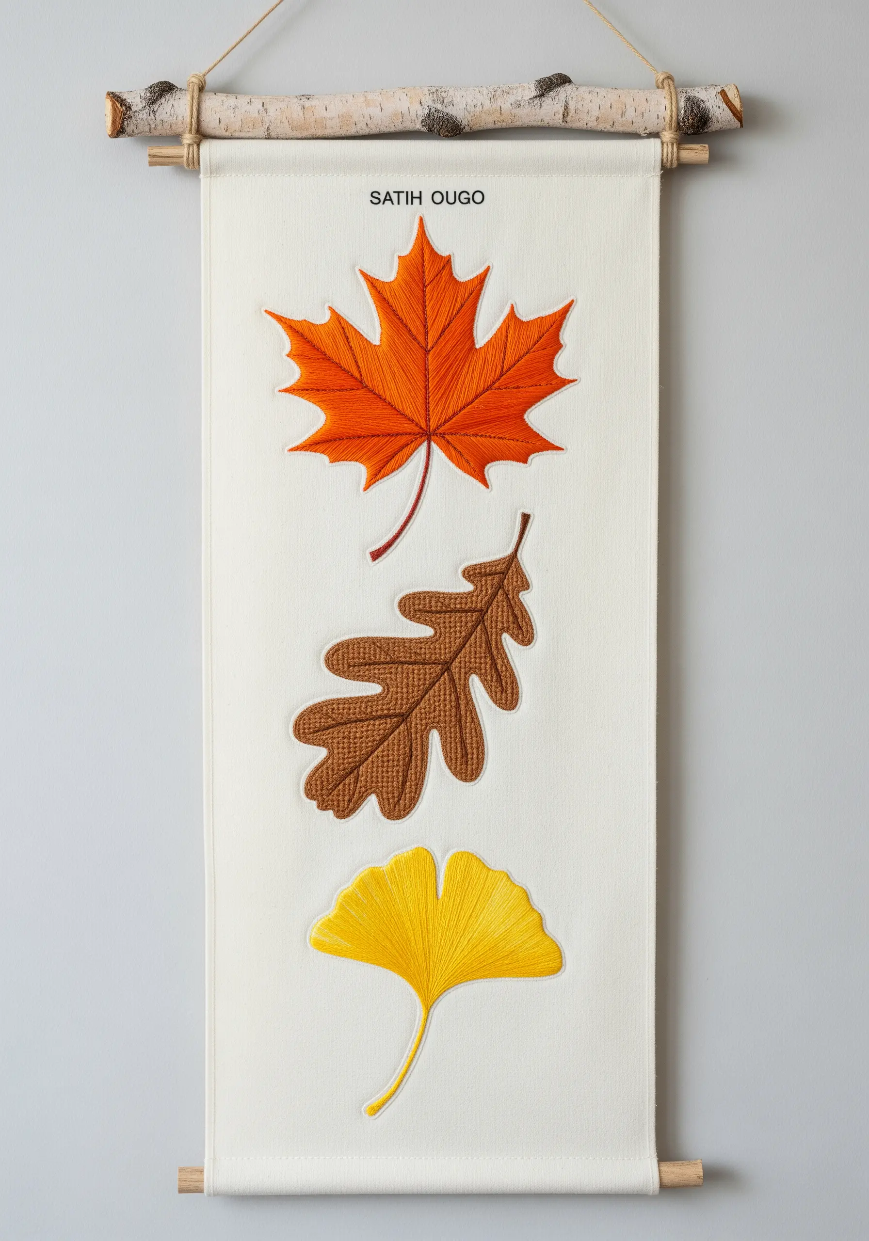 Wall hanging with embroidered maple, oak, and ginkgo leaves in autumn colors.