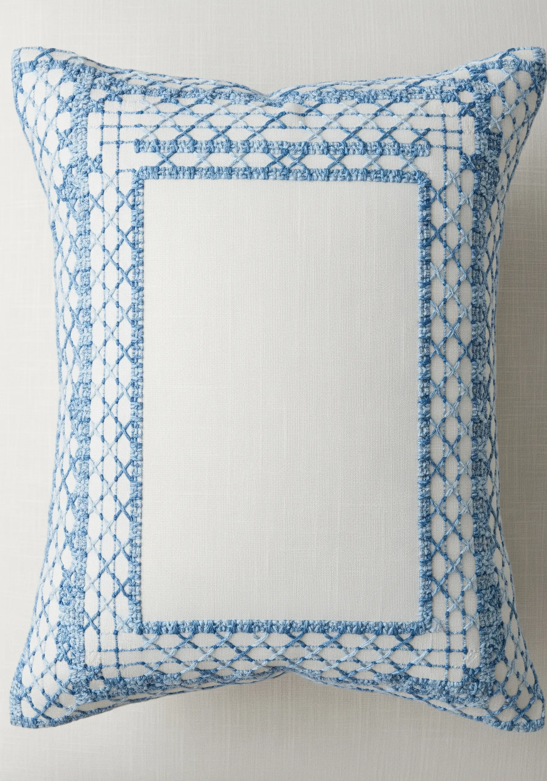 A trellis pattern embroidered with a variegated blue and white thread for a faded effect