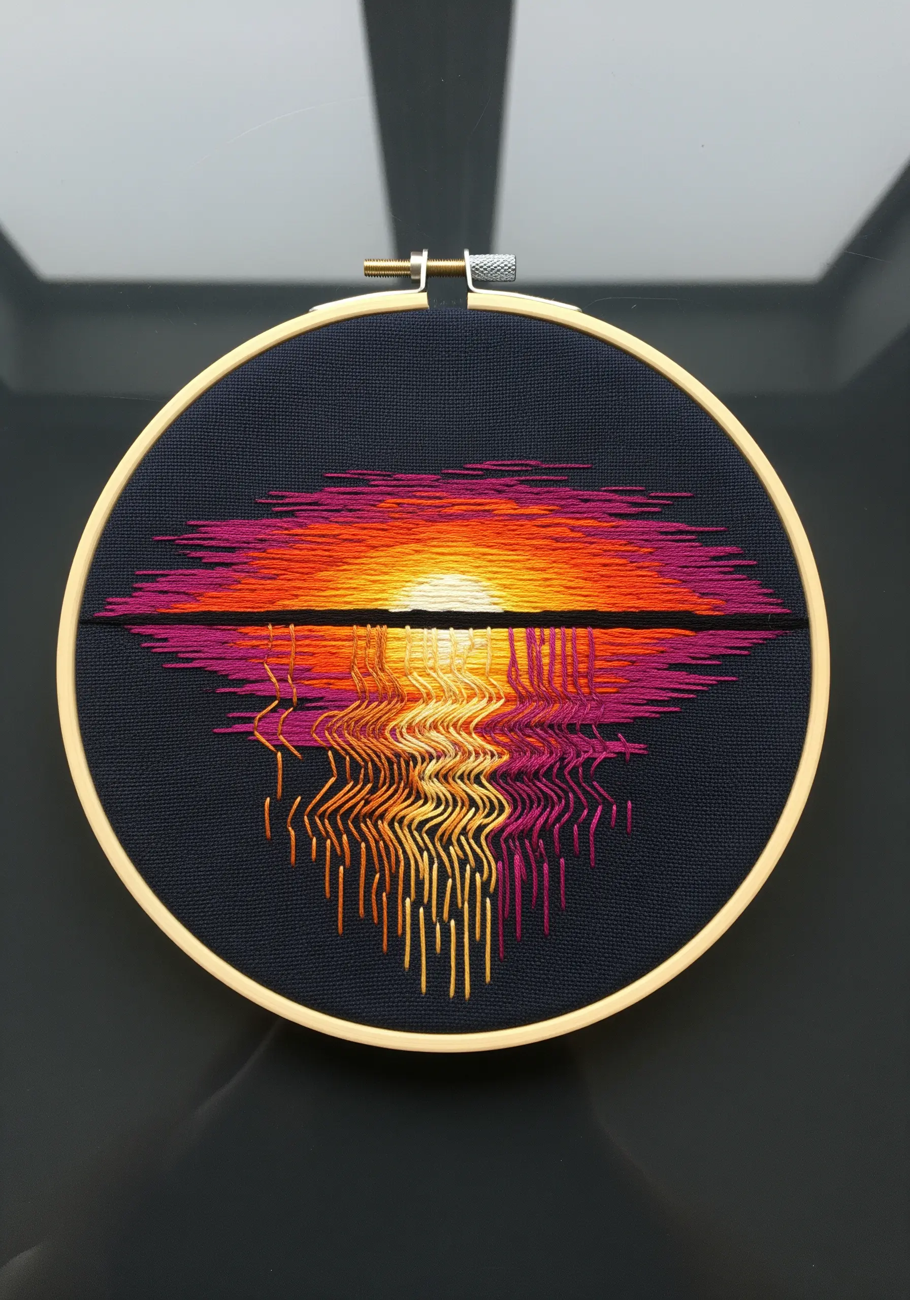 Embroidery of a sunset reflection on water with a colorful, distorted 'glitch' effect.