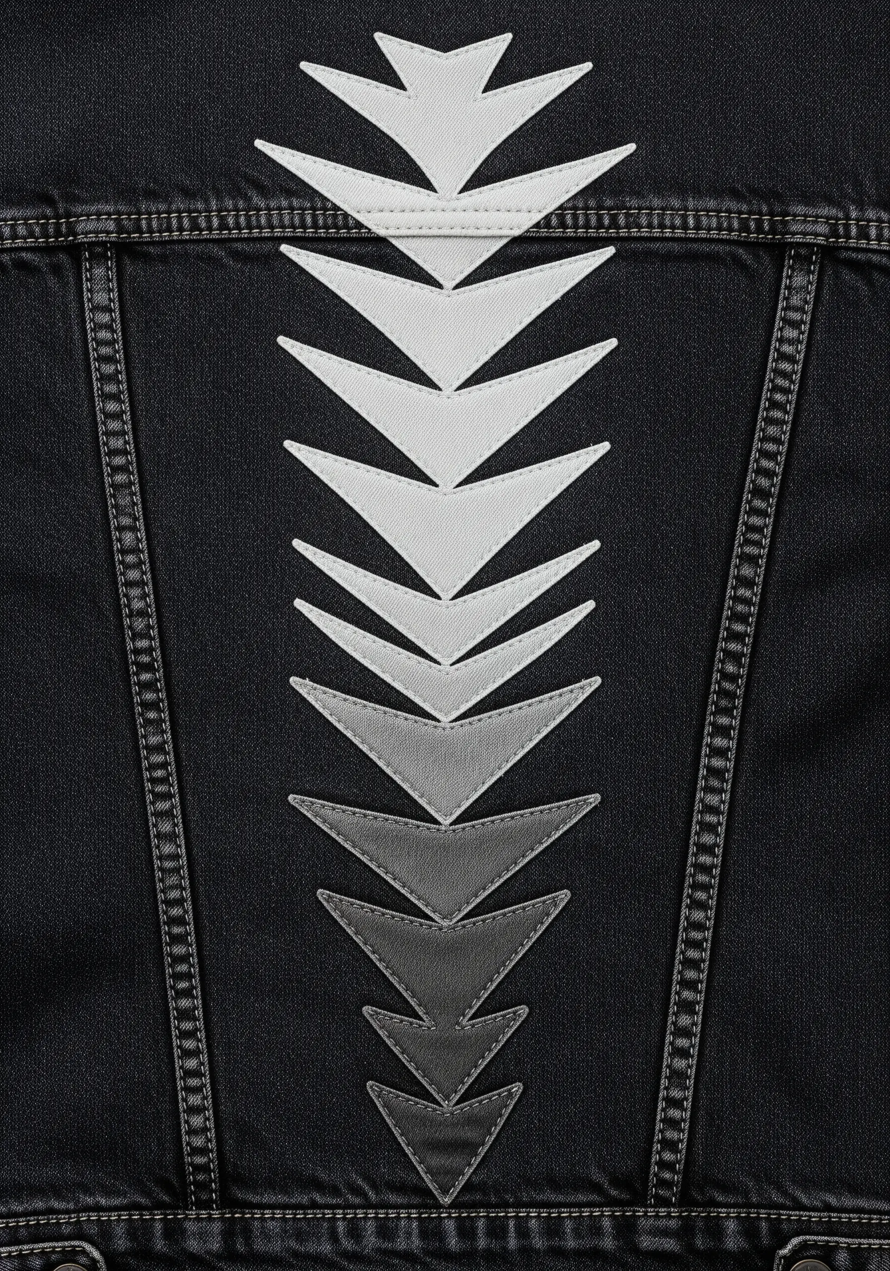 A vertical spine of geometric, arrow-like shapes in a white-to-black gradient on a black jacket.