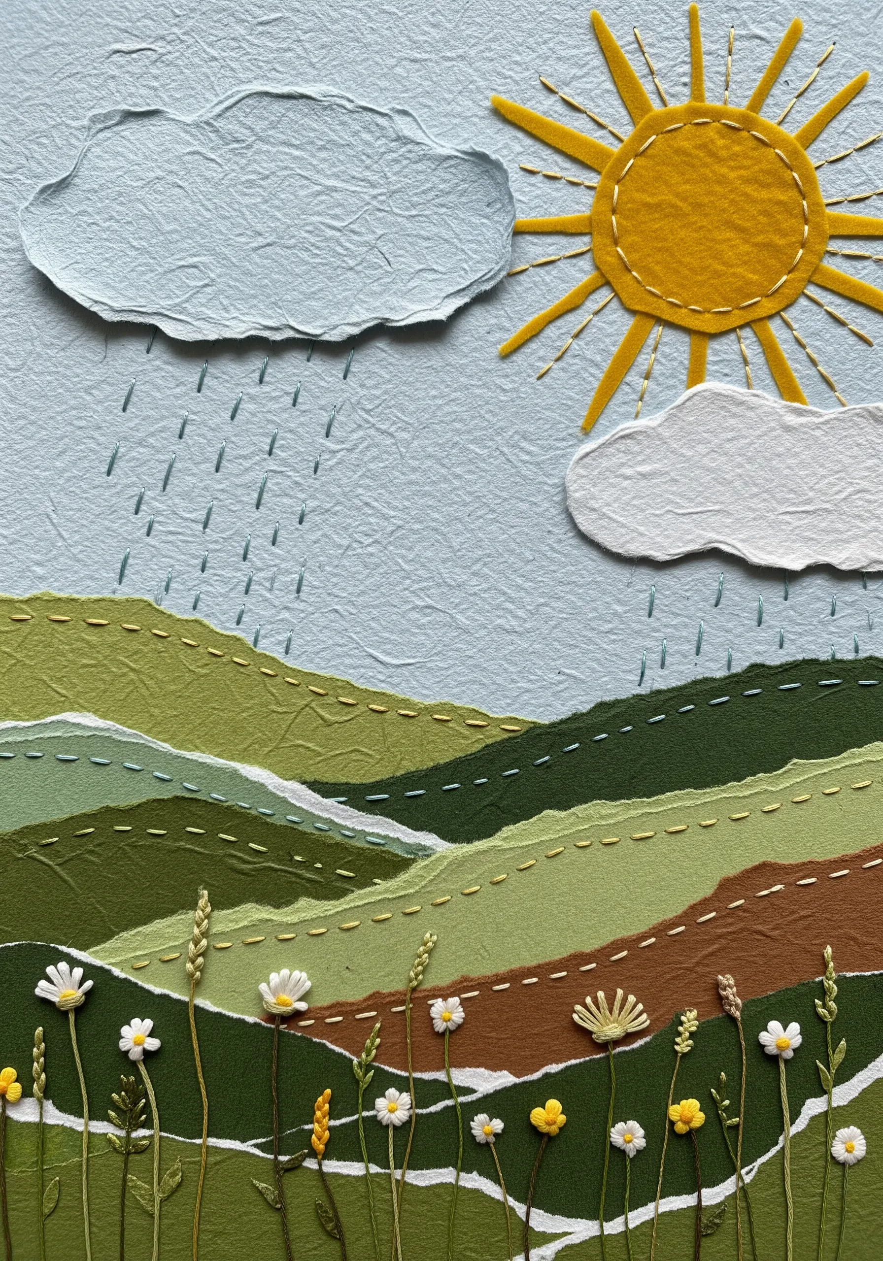 A landscape collage made from torn paper and accented with simple running stitches.