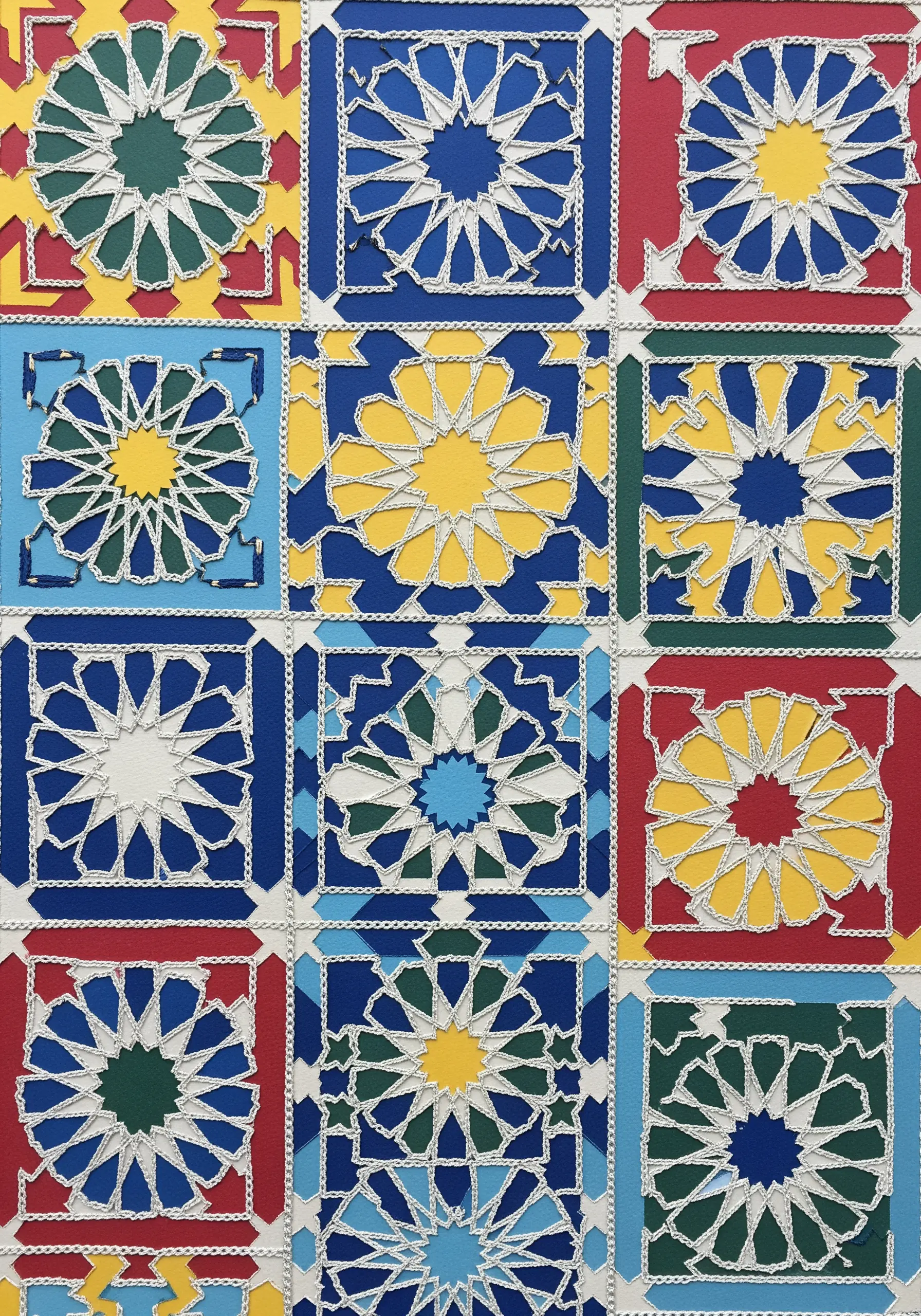 A mosaic of colorful geometric paper tiles stitched together with white thread.
