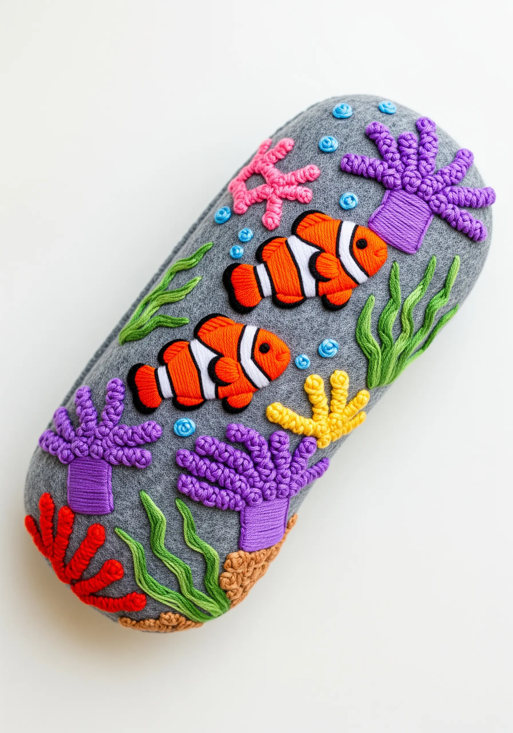 A felt glasses case embroidered with a dimensional underwater scene with clownfish and coral.