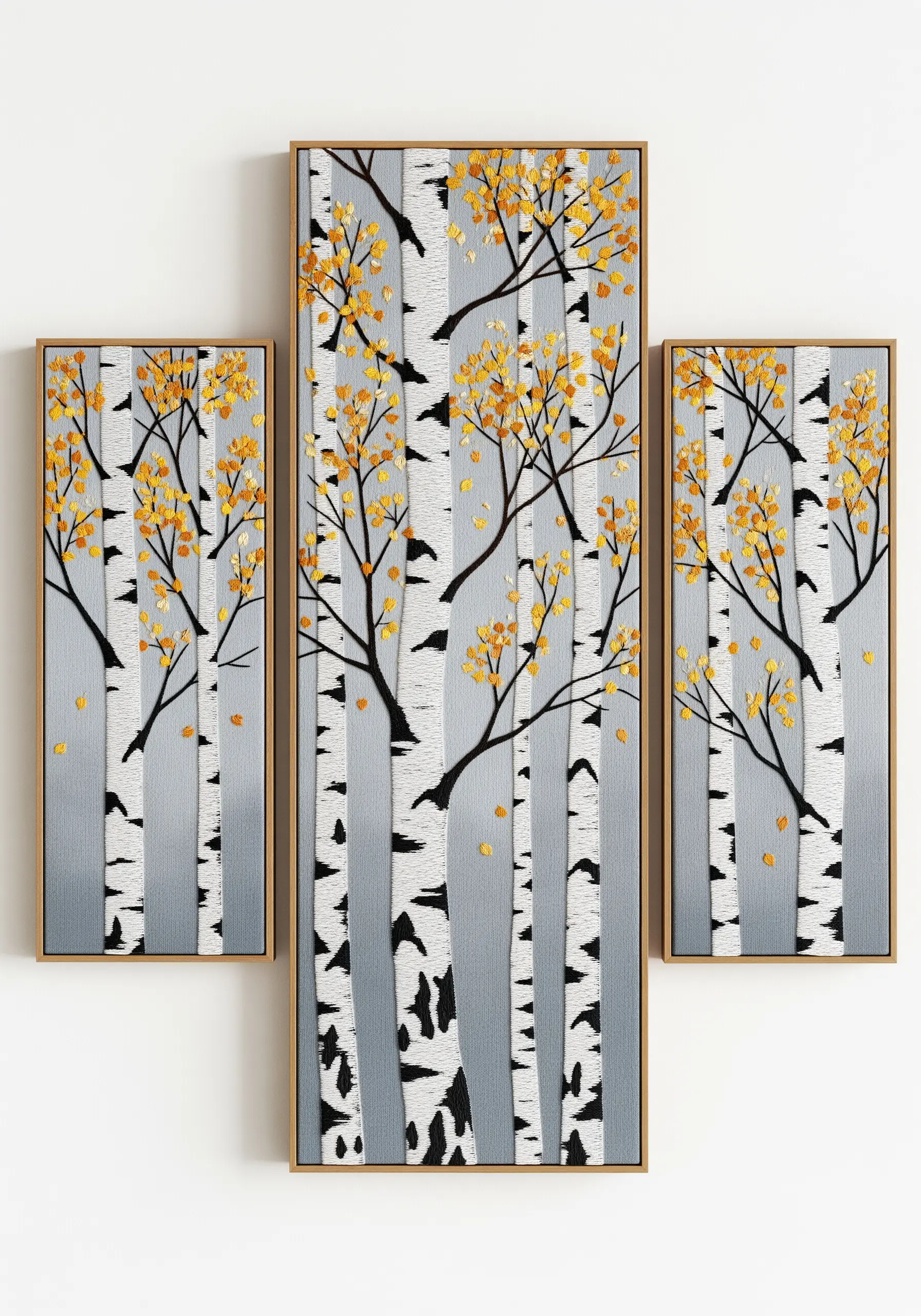 A three-panel framed embroidery piece (triptych) showing birch trees in autumn.