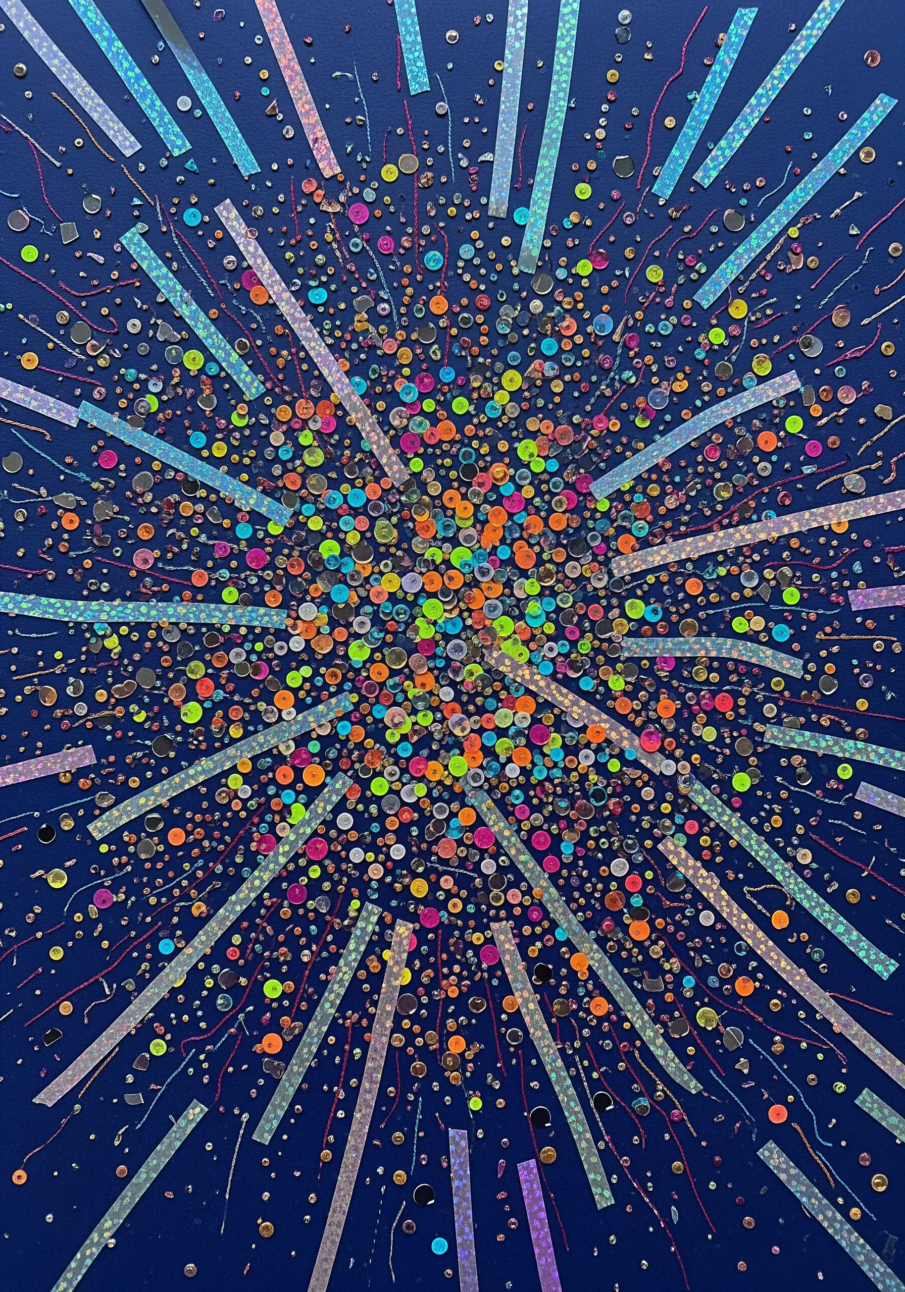 A burst of colorful paper dots and holographic strips on a dark background.