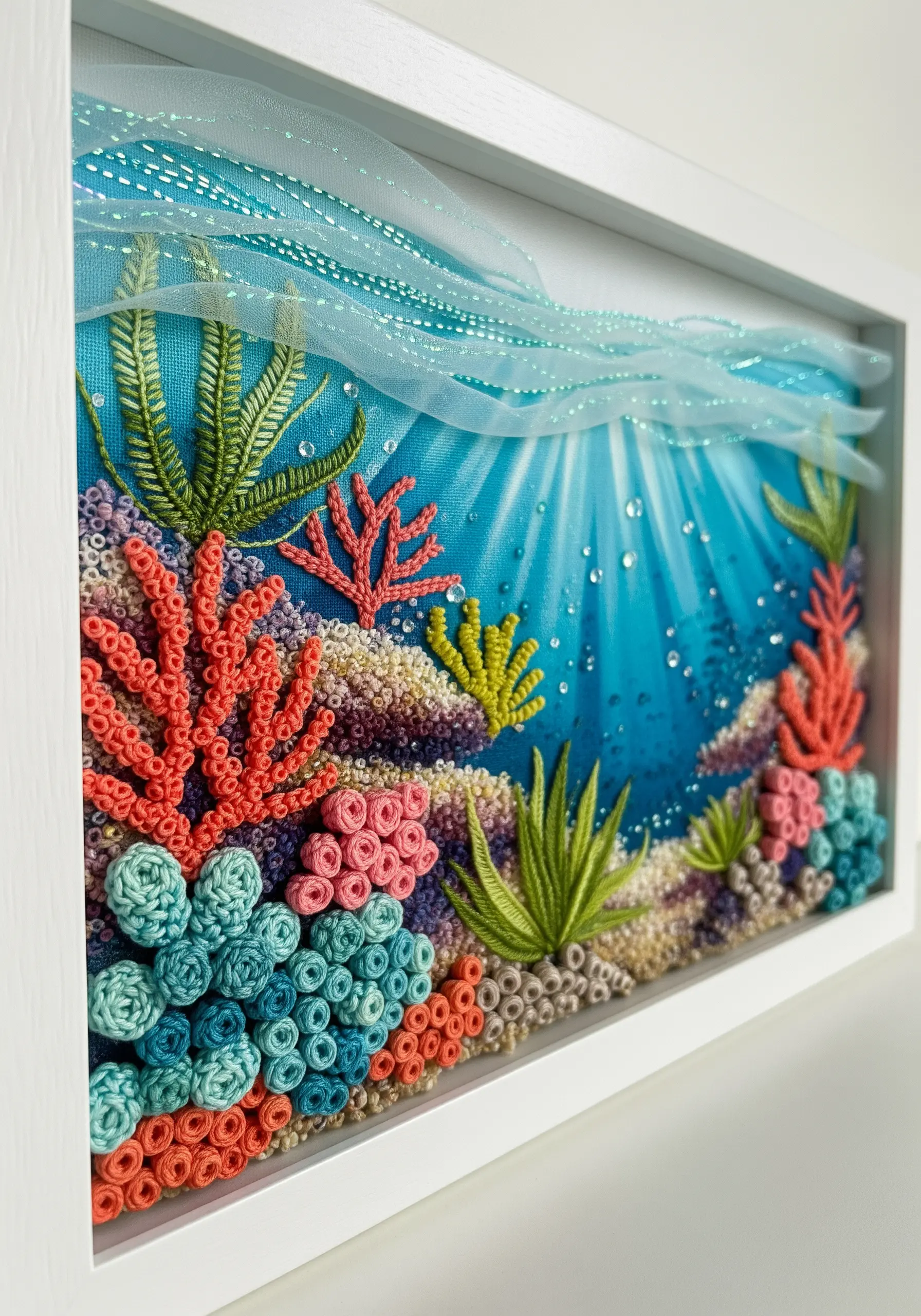 A colorful 3D coral reef embroidery in a shadow box, featuring a variety of textural stitches.