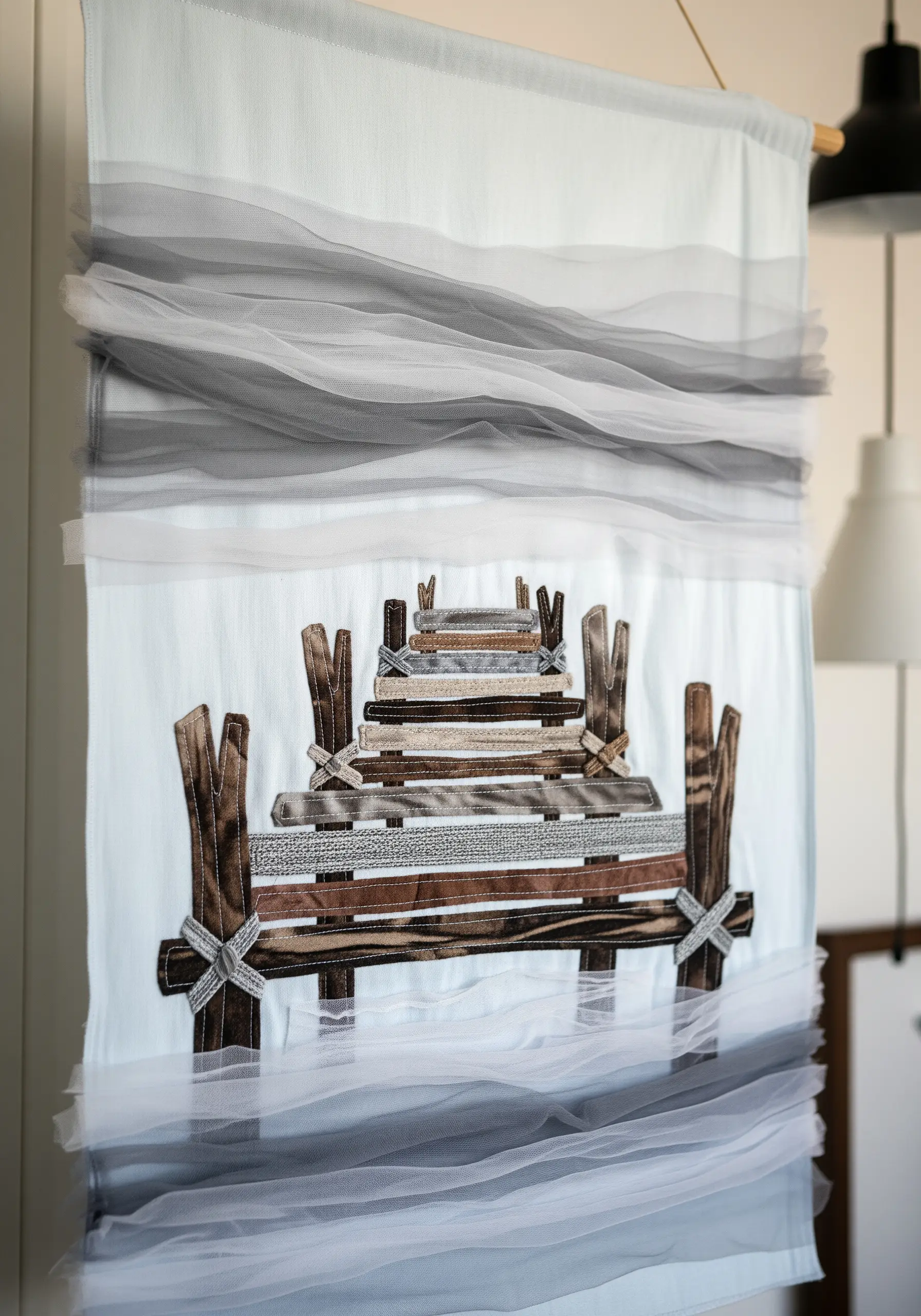 A fabric collage of a wooden dock with layers of gray tulle creating a misty, foggy effect.