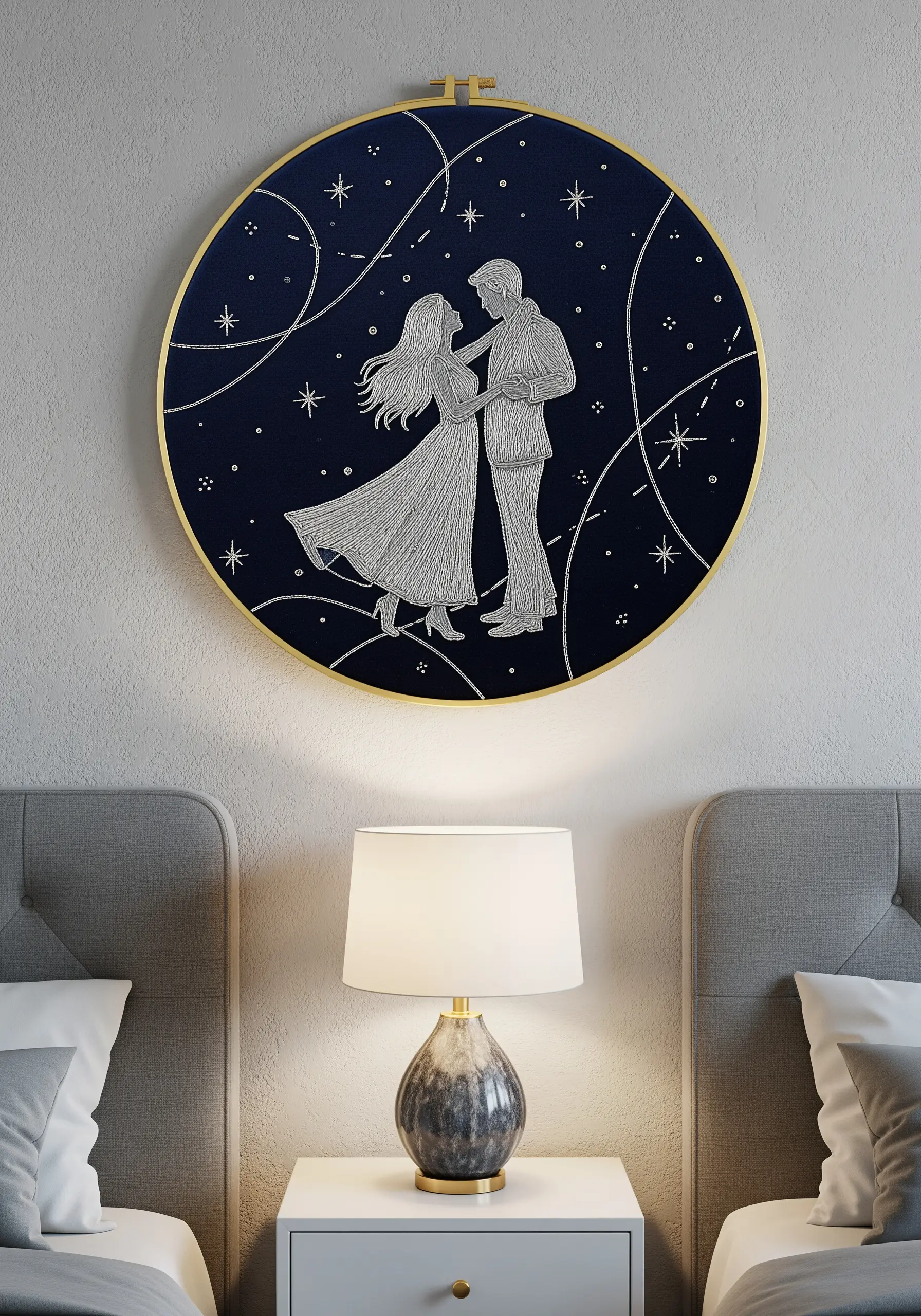 A couple dancing under swirling stars, stitched in white thread on navy blue fabric.