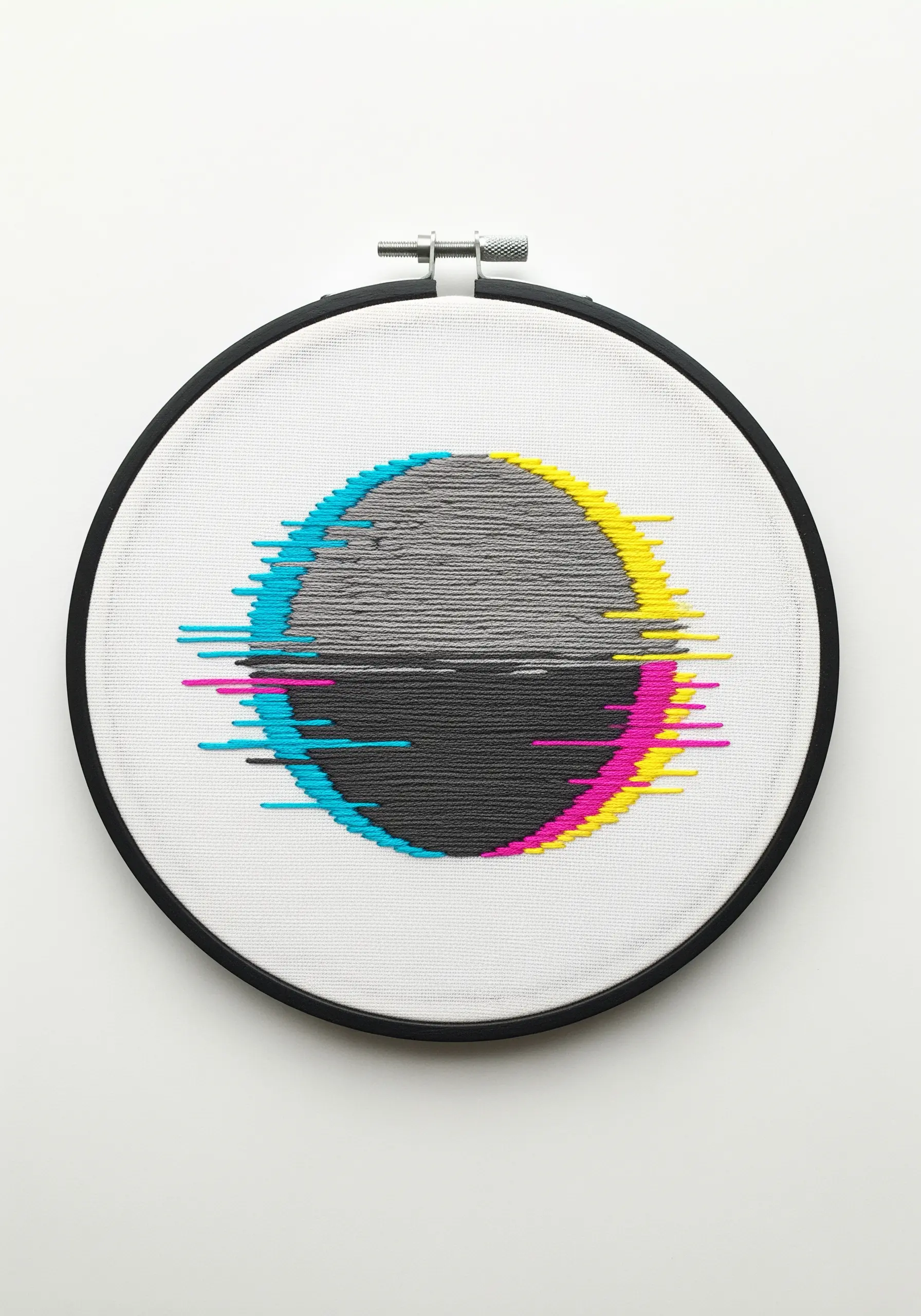 Embroidery of a circle with a CMYK color glitch effect against a grey background.