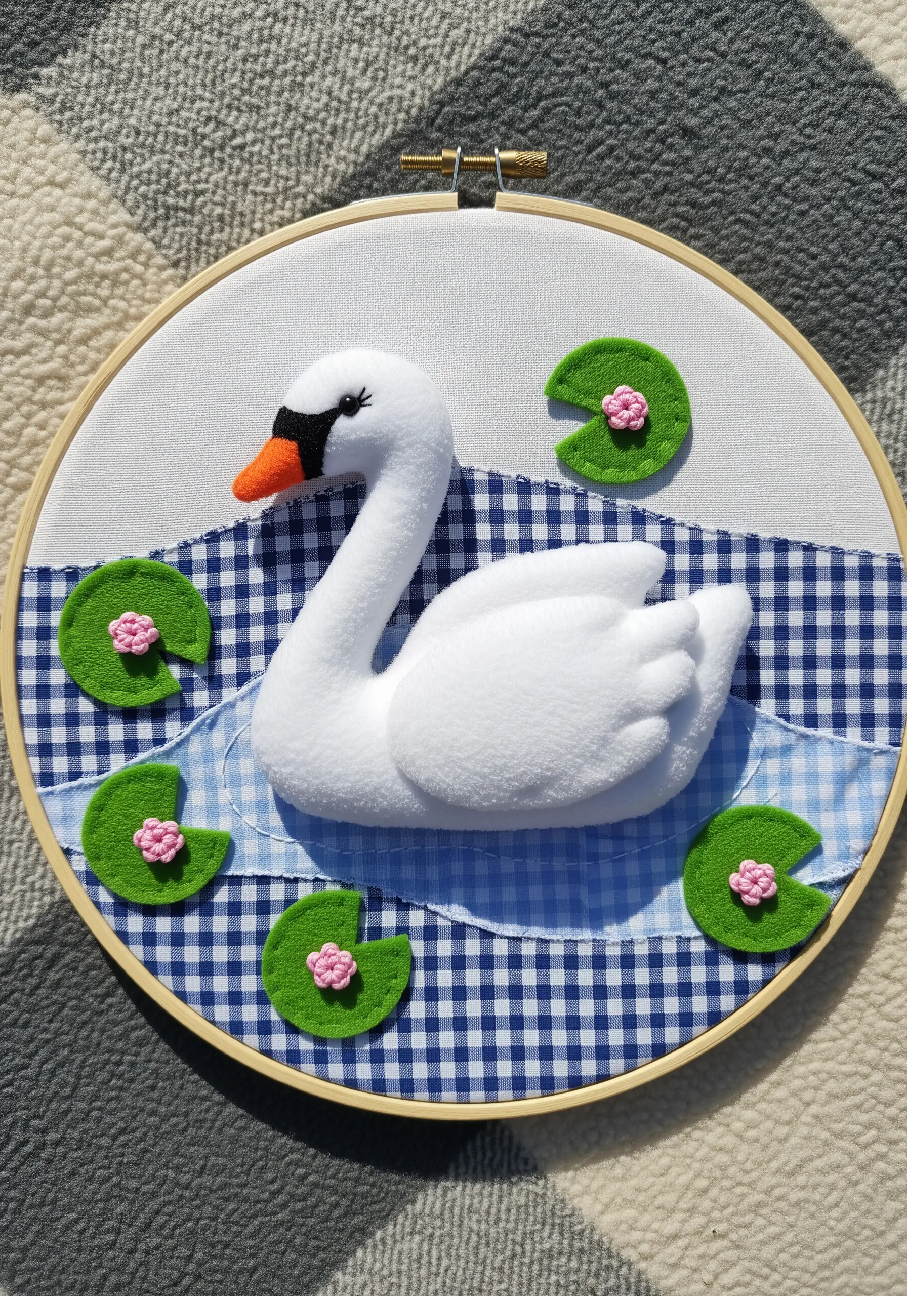 Hoop art with a 3D padded felt swan on a blue and white gingham background