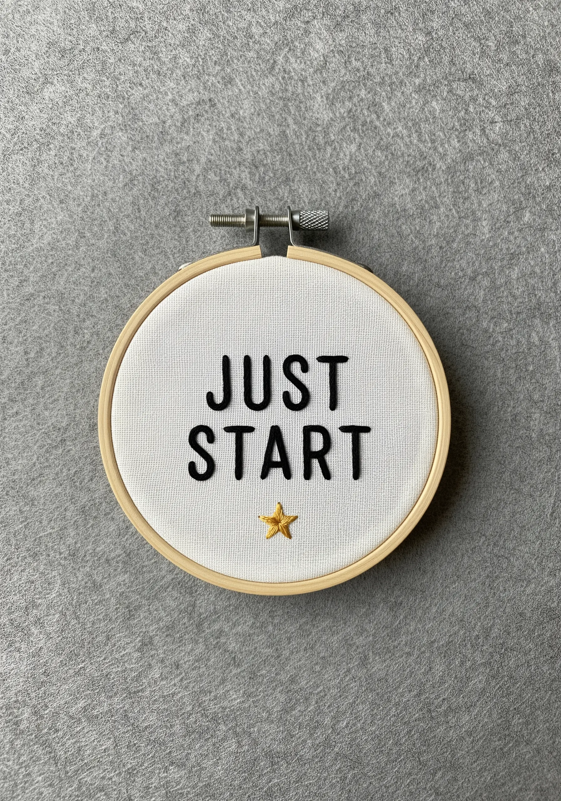 Padded black satin stitch text 'JUST START' with a small gold star.