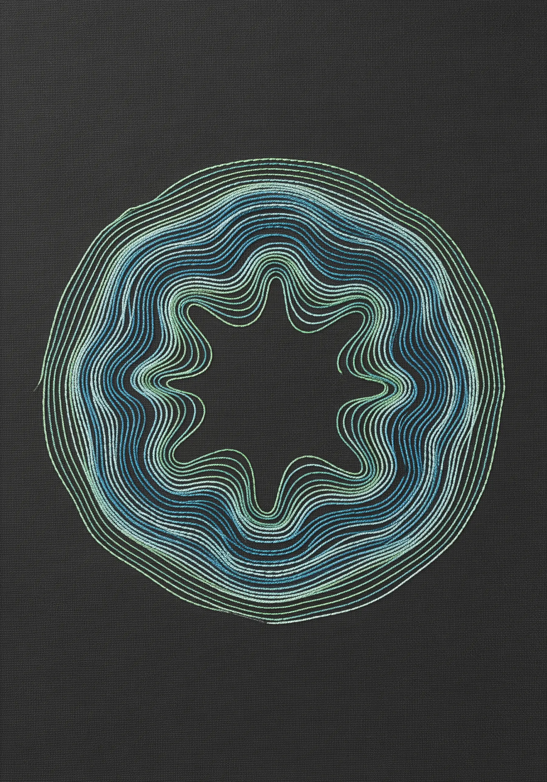 Concentric, wavy outlines in blue and green thread creating a hypnotic ripple effect.