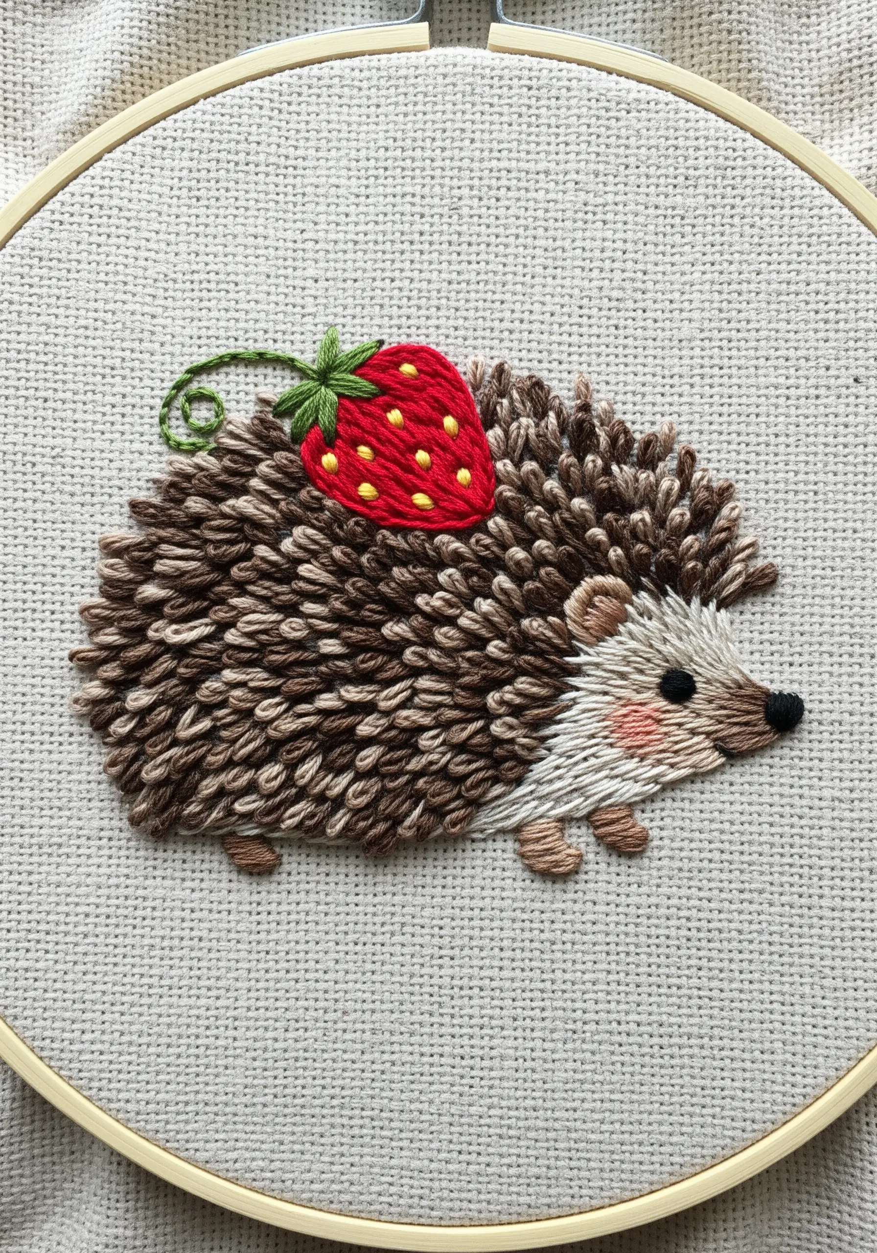 Textured hedgehog embroidery using layered straight stitches to create spiky fur.