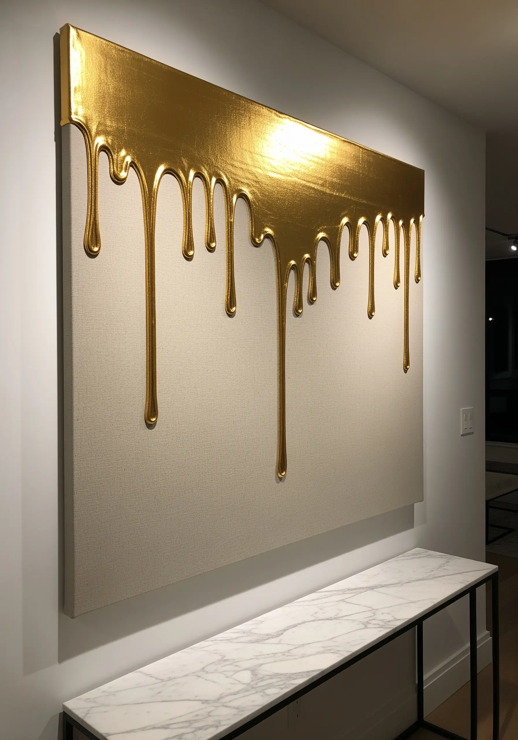 Wall art with a 3D effect of dripping gold paint, created with raised metallic embroidery.