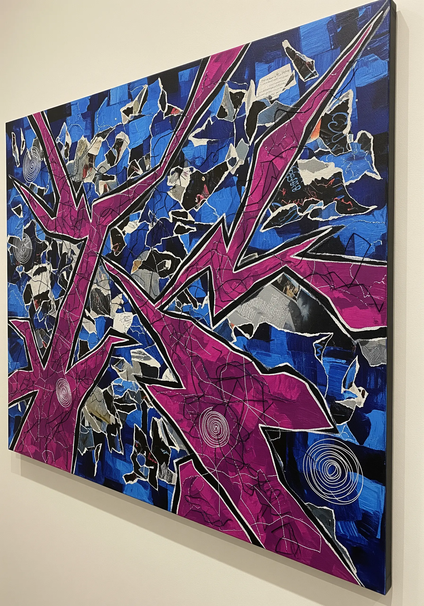 An abstract graffiti-style artwork with stitched outlines over a chaotic paper collage.