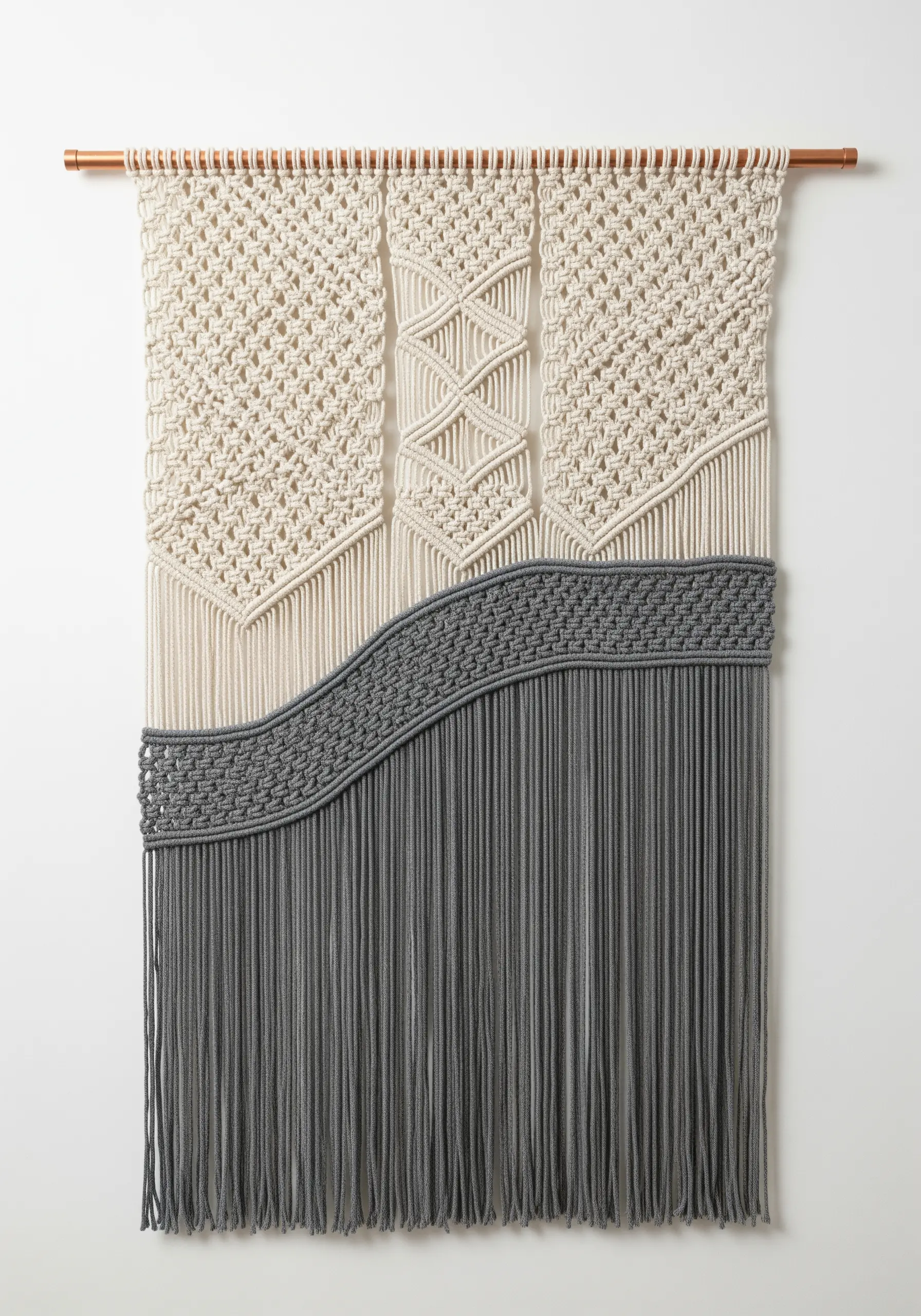Macrame wall hanging with distinct panels of different knots in cream and gray.