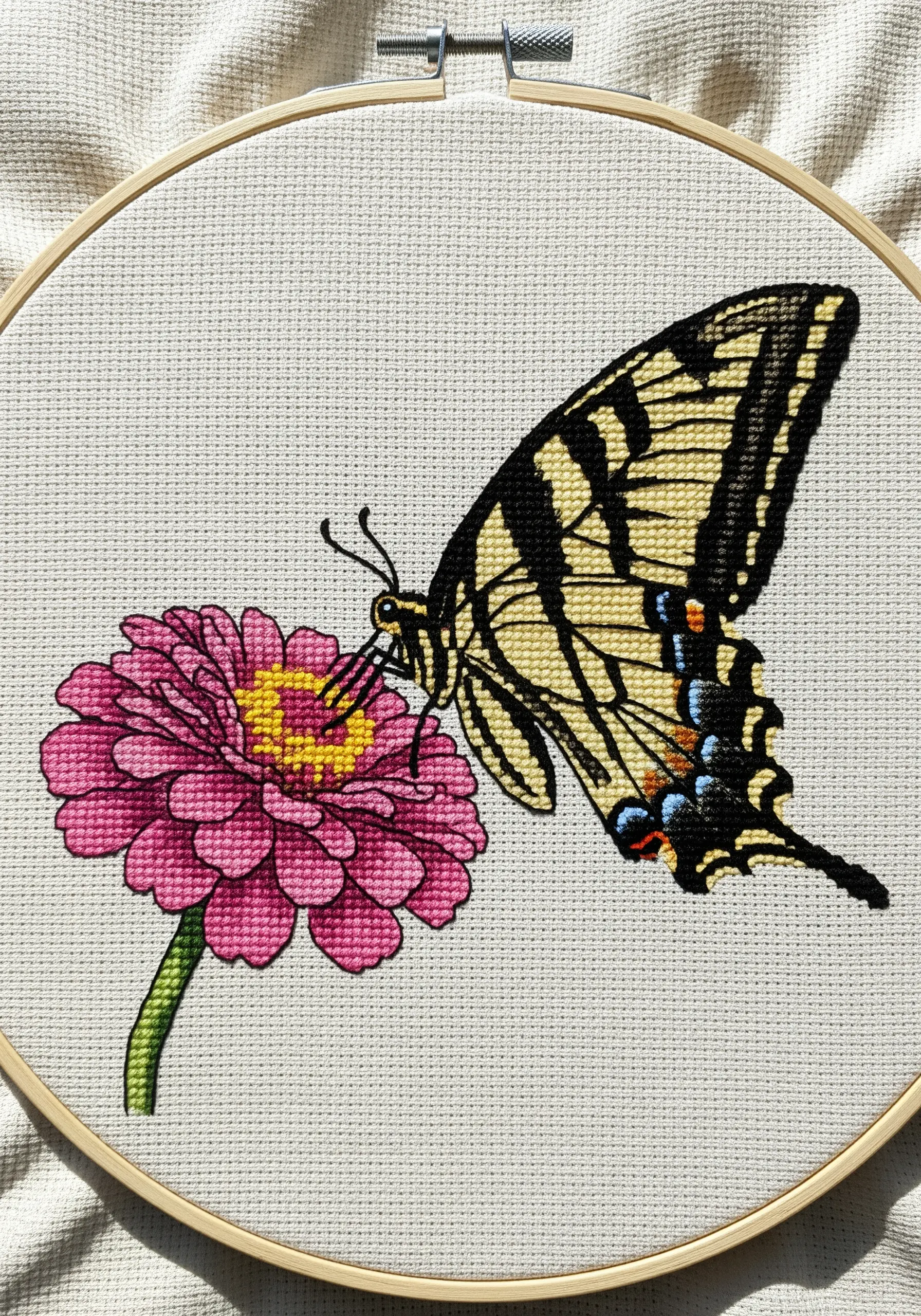 A cross-stitched swallowtail butterfly on a pink zinnia flower.