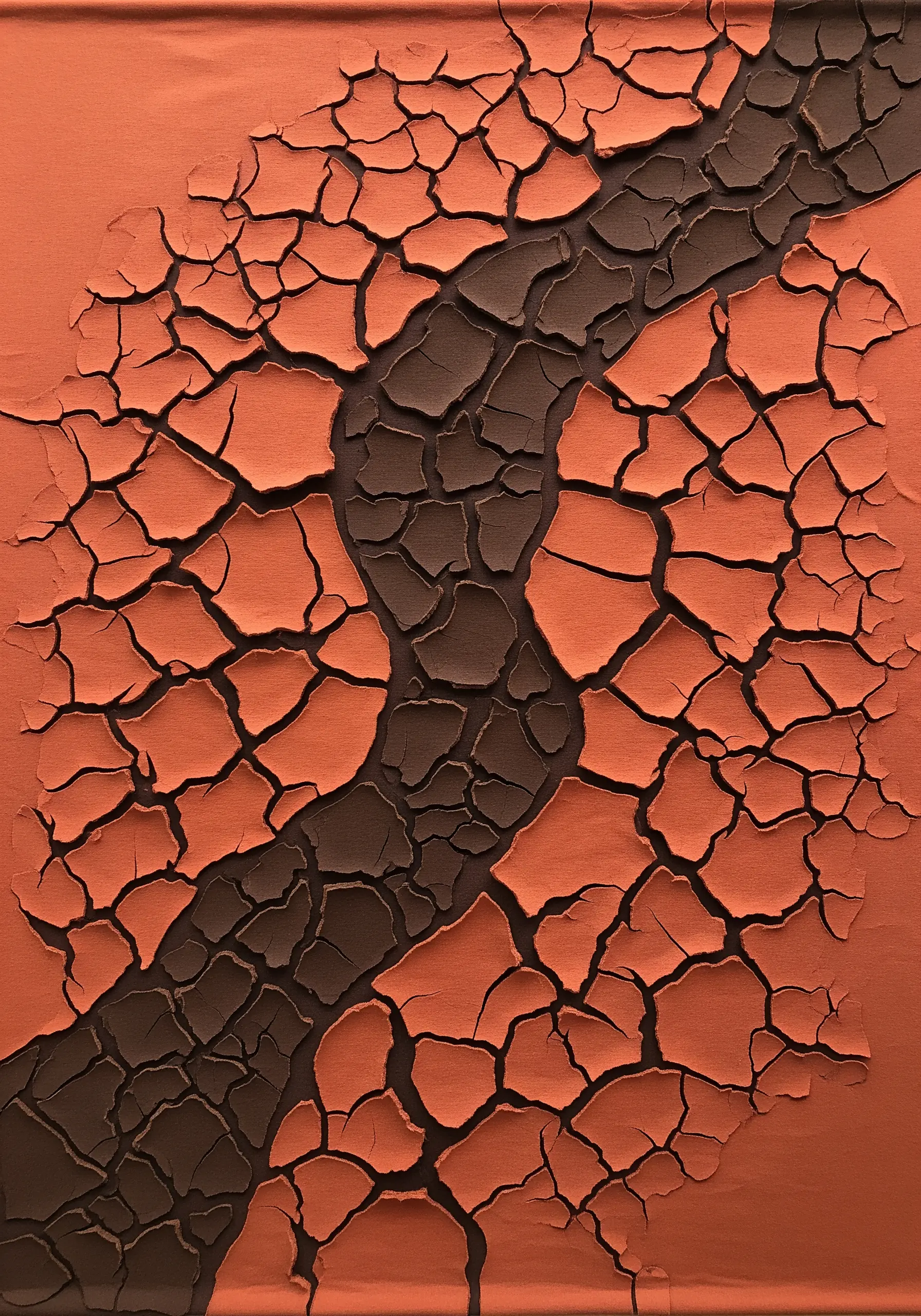 A mixed-media textile piece showing cracked orange earth over a dark brown background.