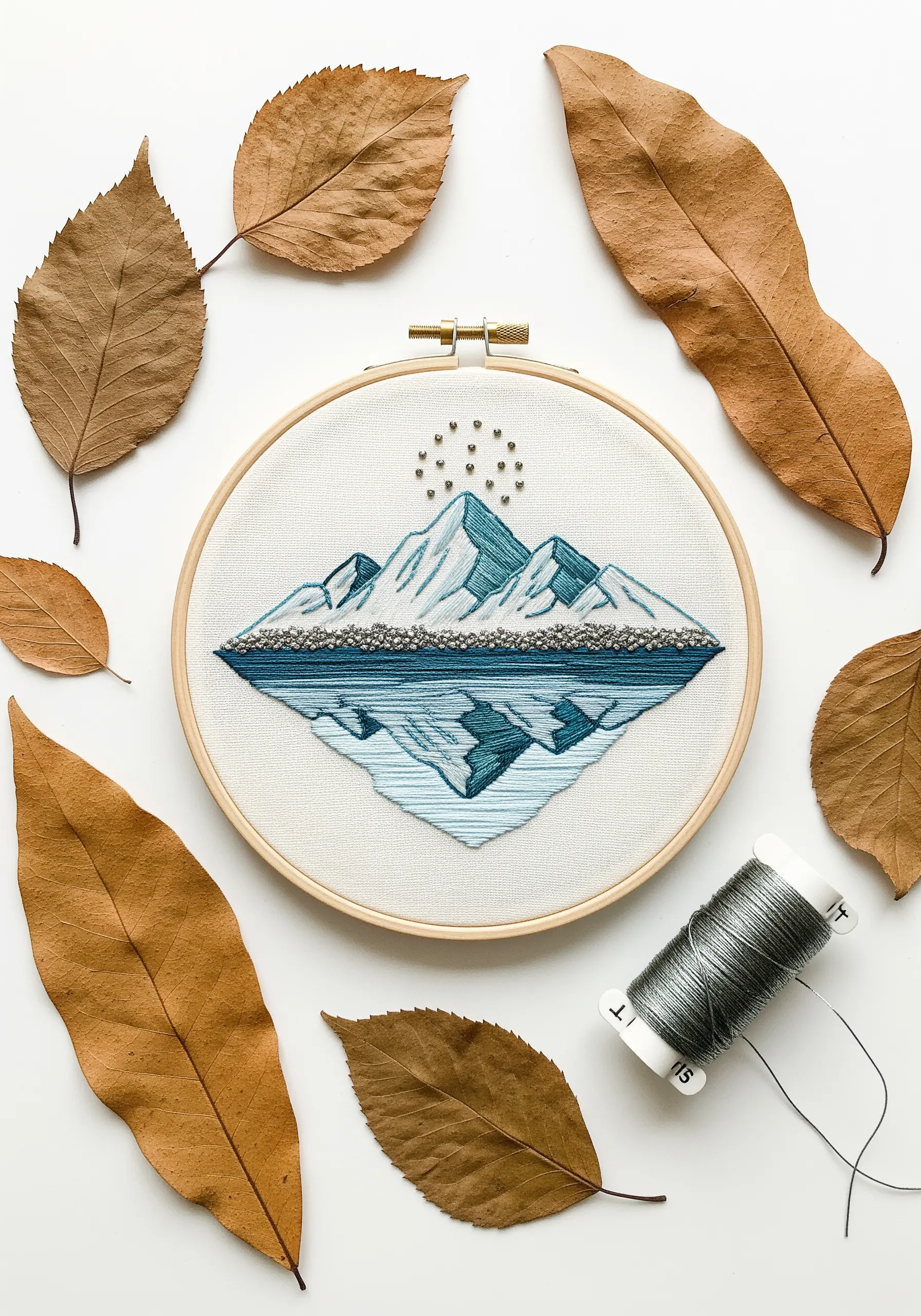 Mountain embroidery with a perfectly symmetrical satin stitch water reflection.