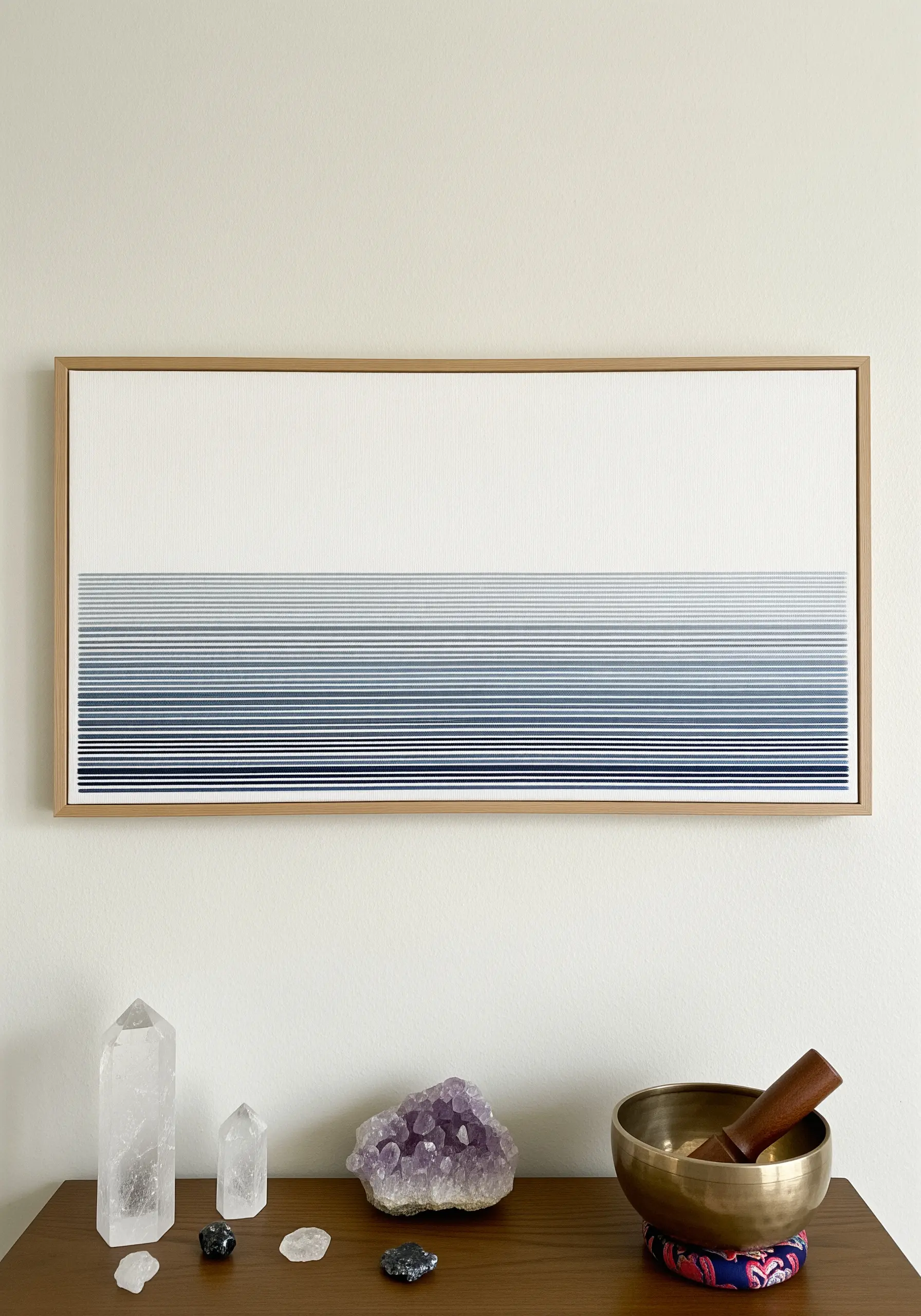 A framed piece of embroidery with horizontal lines transitioning in a blue gradient.