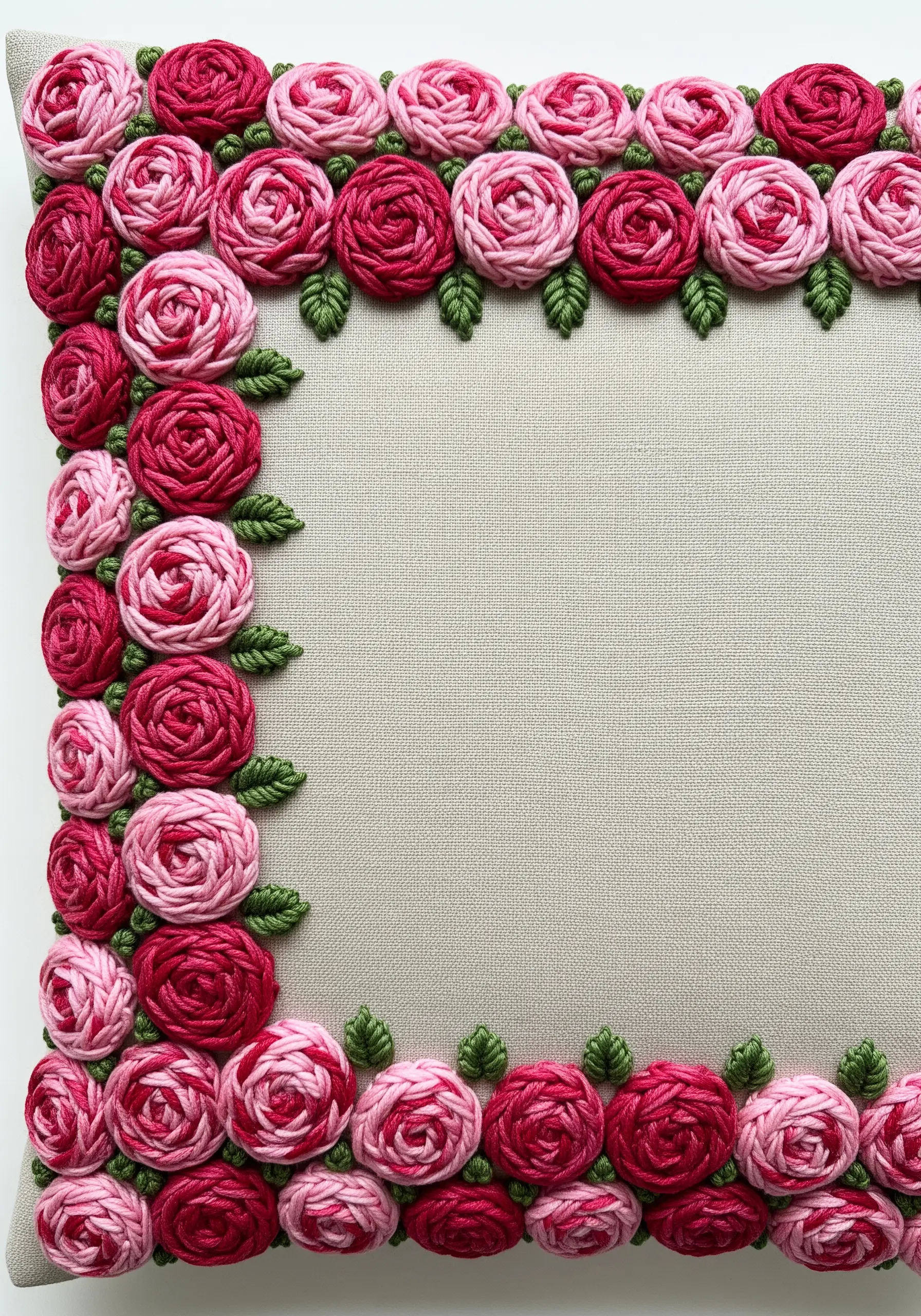 A dense border of dimensional pink and red roses made with woven wheel stitch