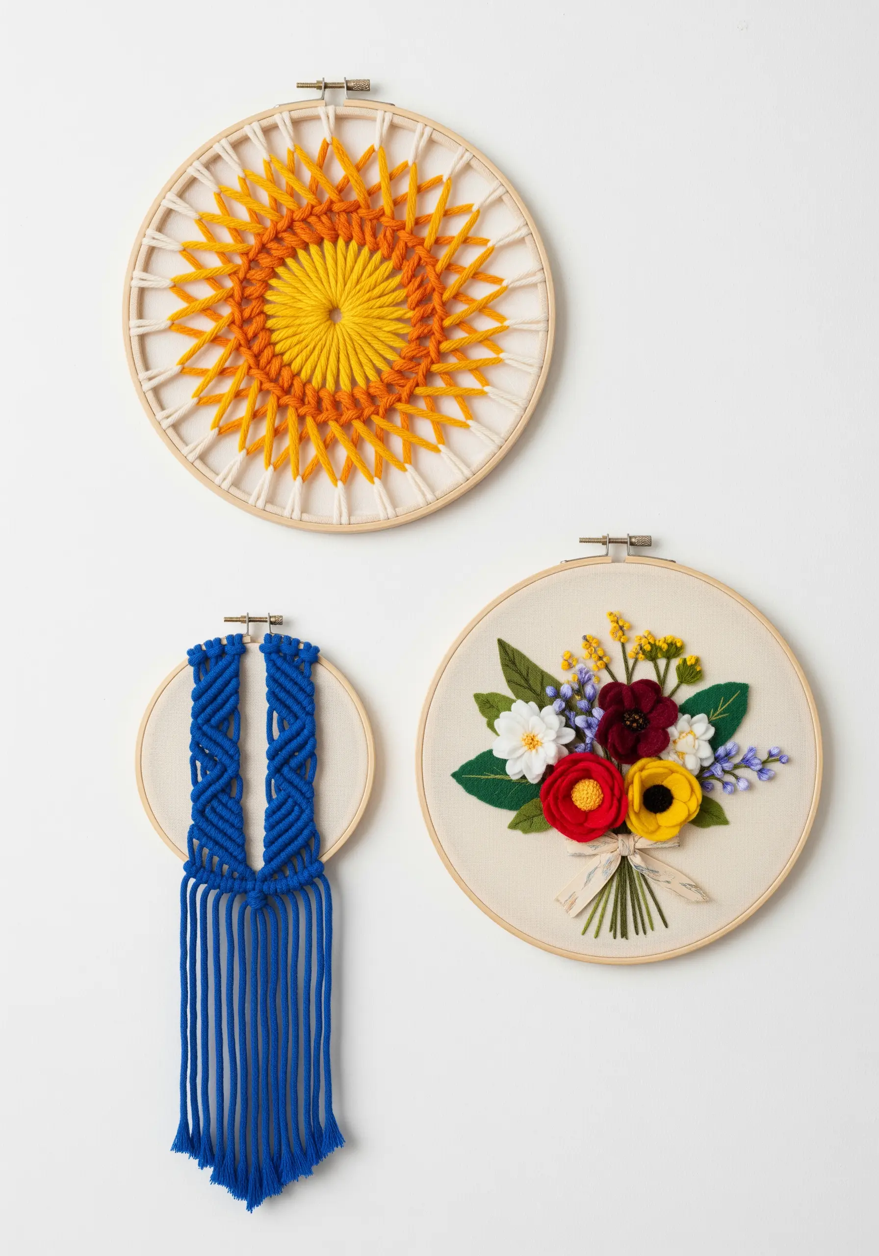 A trio of wall art hoops featuring string art, macrame, and 3D felt flower embroidery.