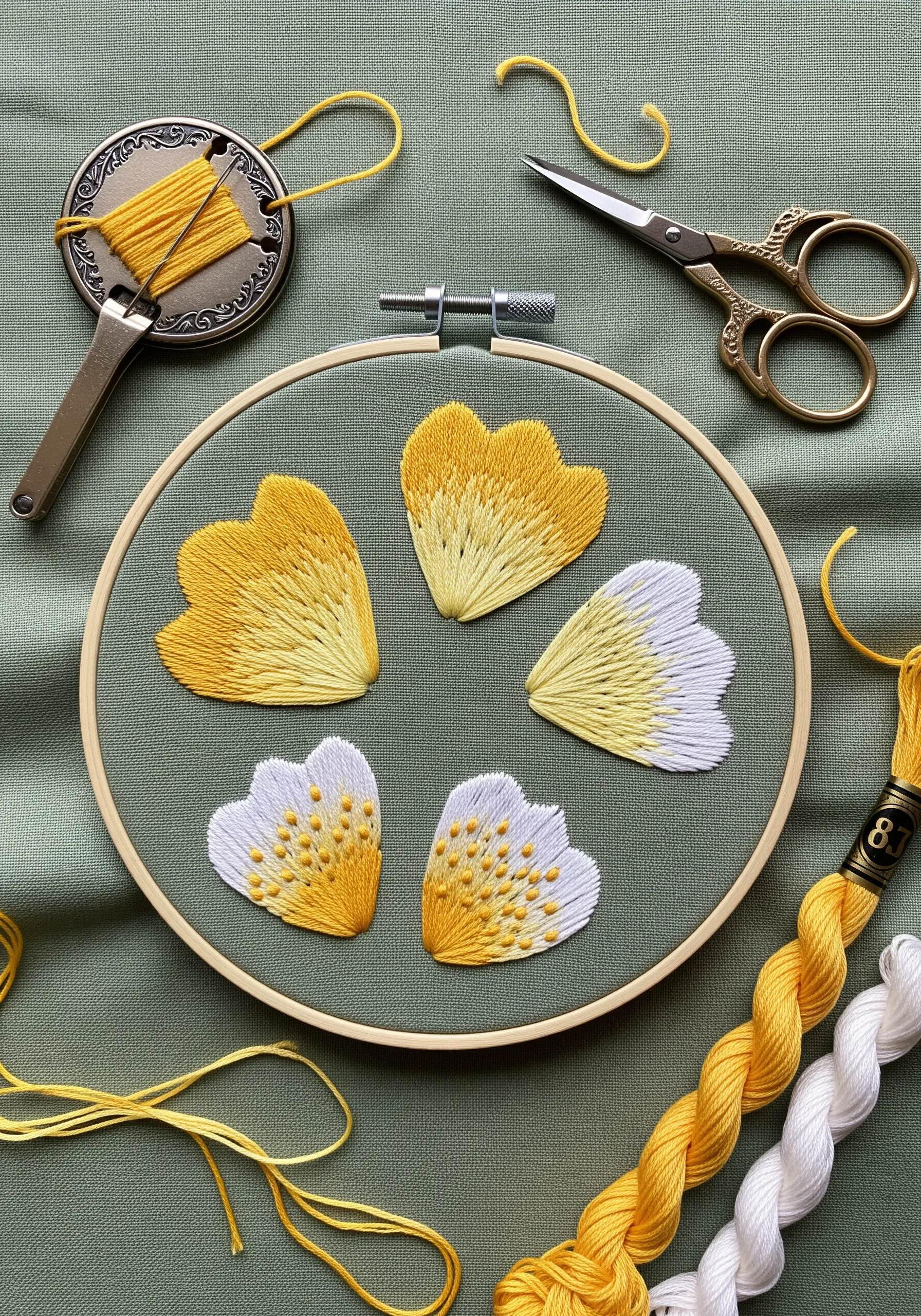 Five embroidered petals showing different yellow-to-white color blending techniques.