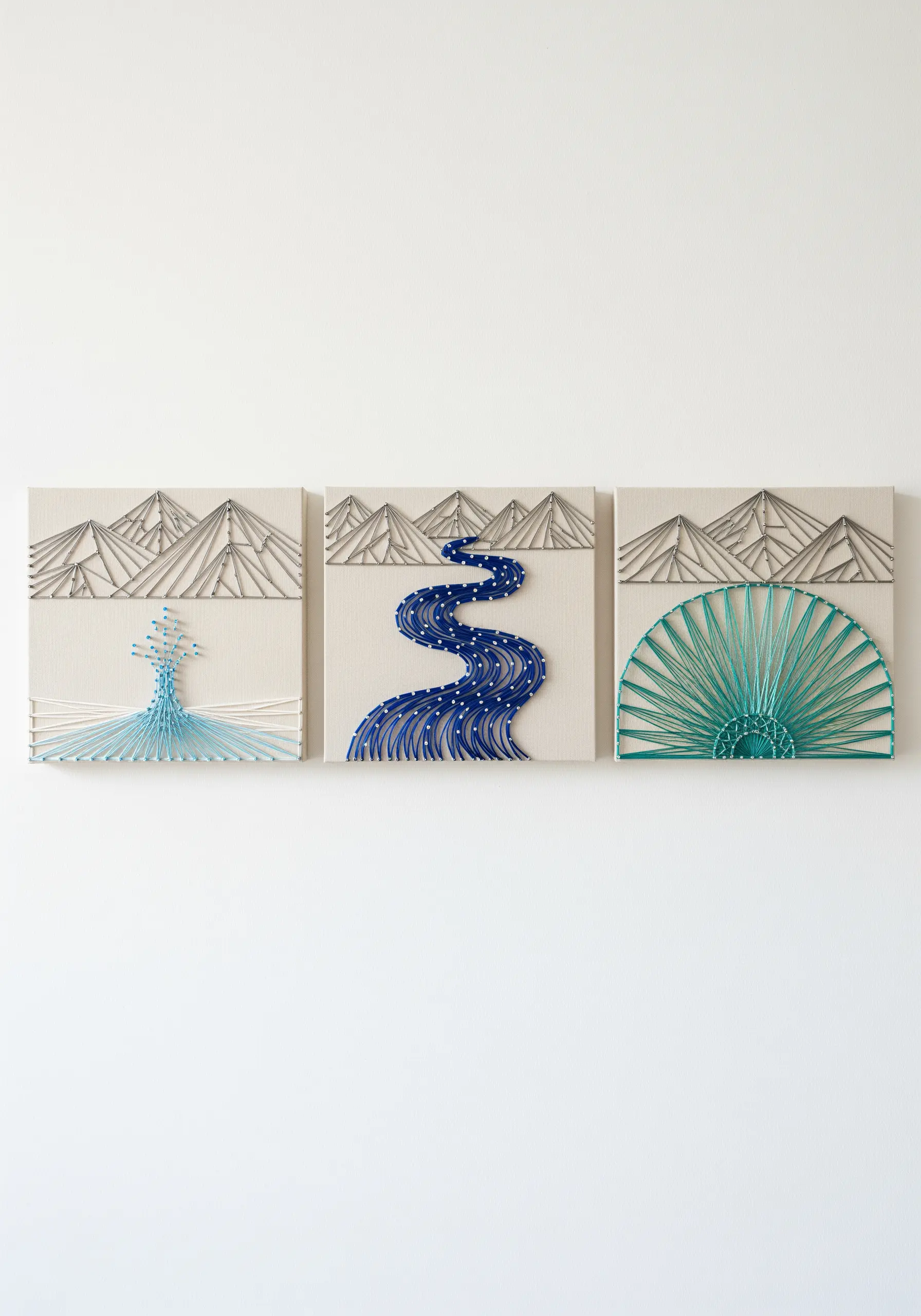 A three-panel string art triptych showing minimalist mountains and river elements.