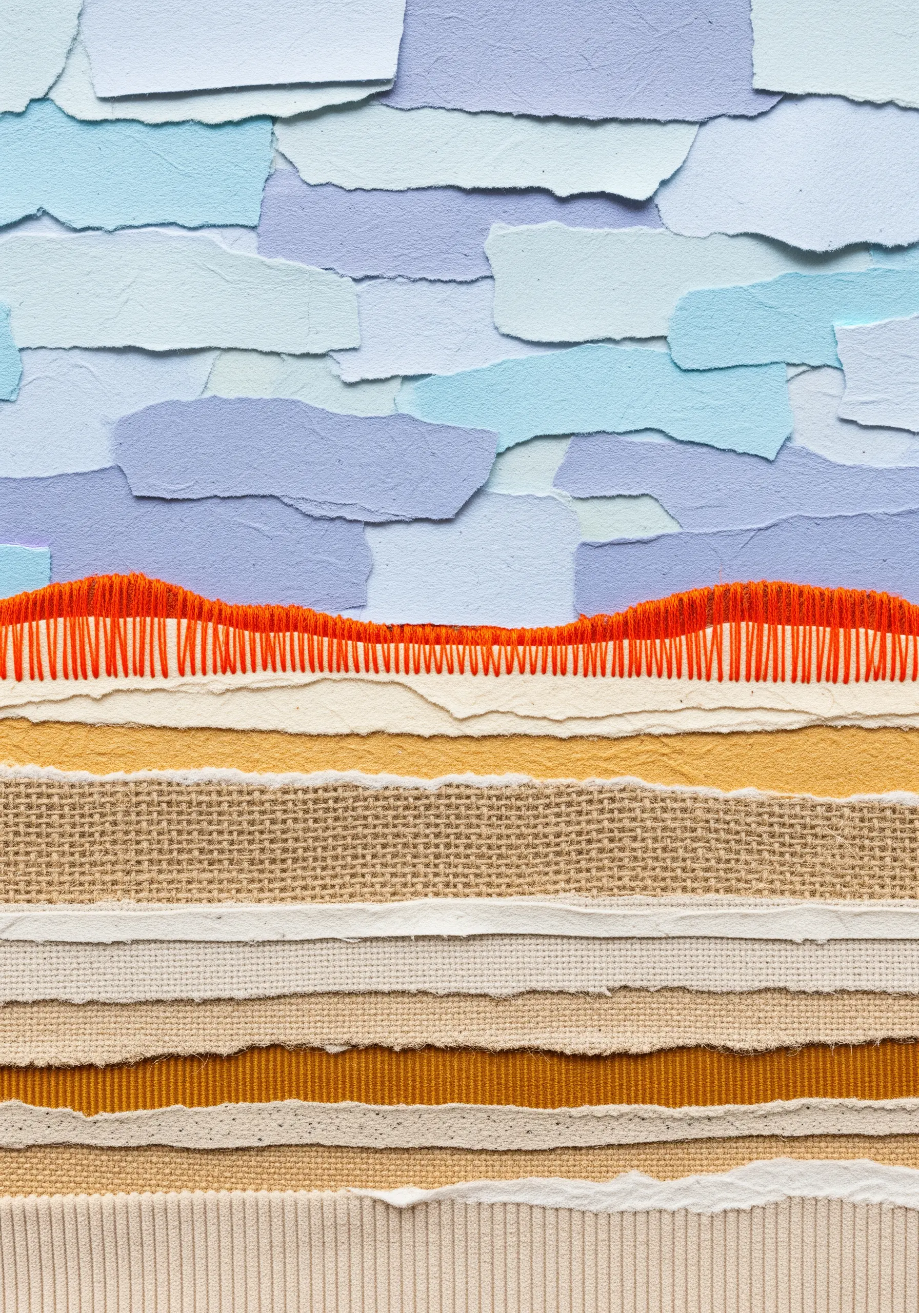 Textured landscape collage of fabric and paper with a bold orange blanket stitch horizon