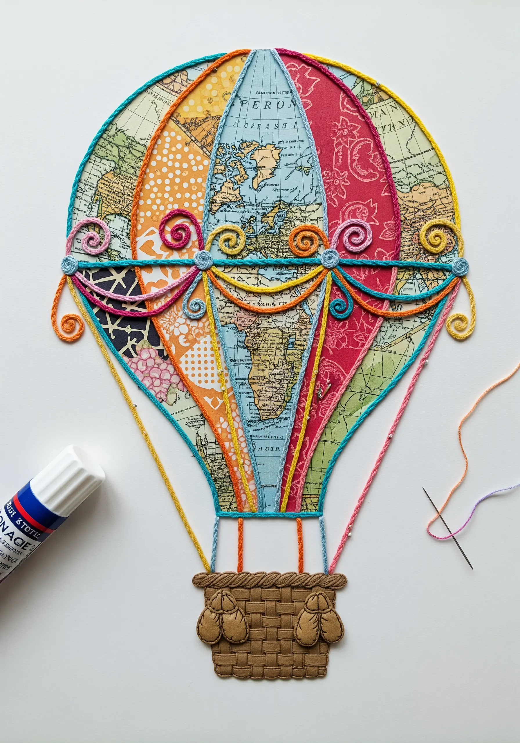 A hot air balloon made of collaged map and pattern paper, outlined with couched yarn.