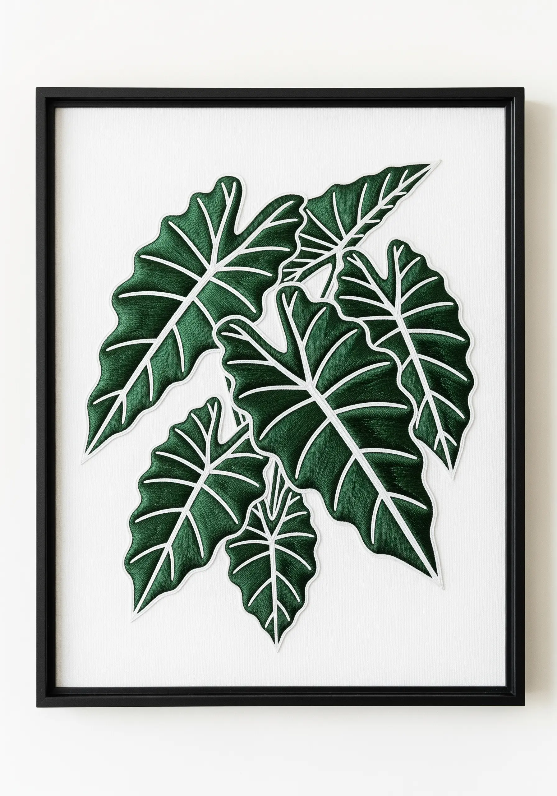 Framed embroidery of Alocasia leaves with bold white outlines and veins.