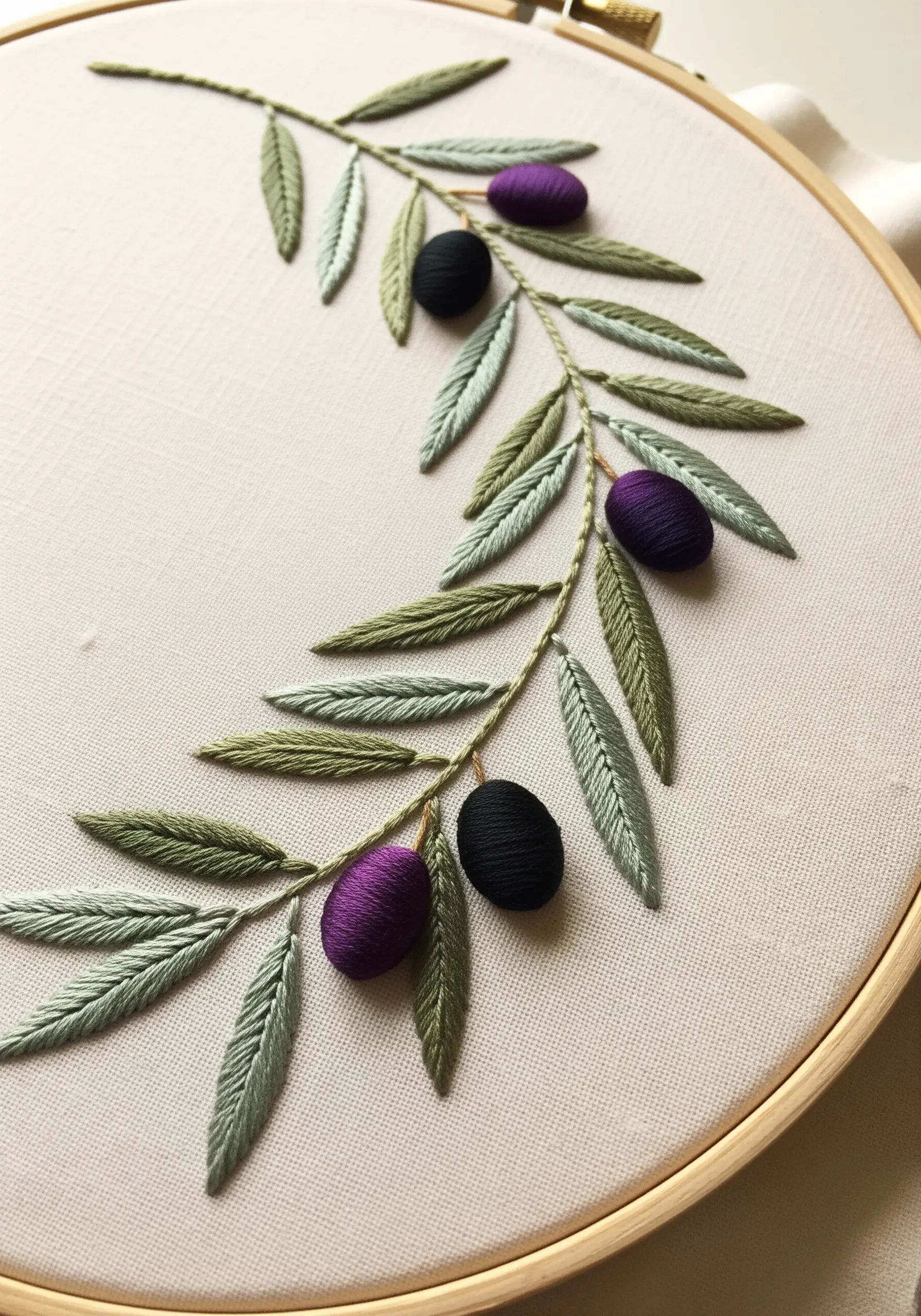 An elegant olive branch with two-toned green leaves and dimensional purple olives.