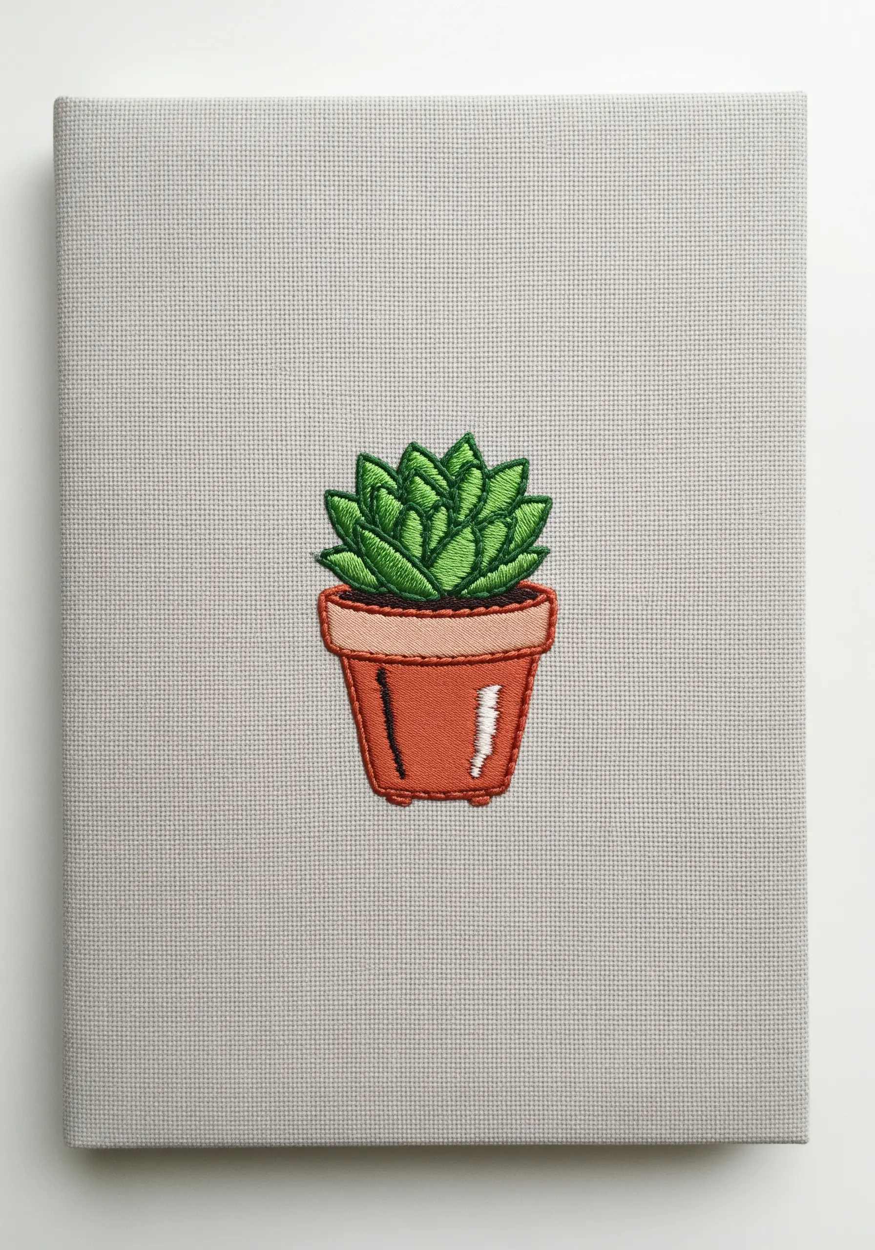 A small, potted succulent embroidered with green satin stitch and dark green outlines.