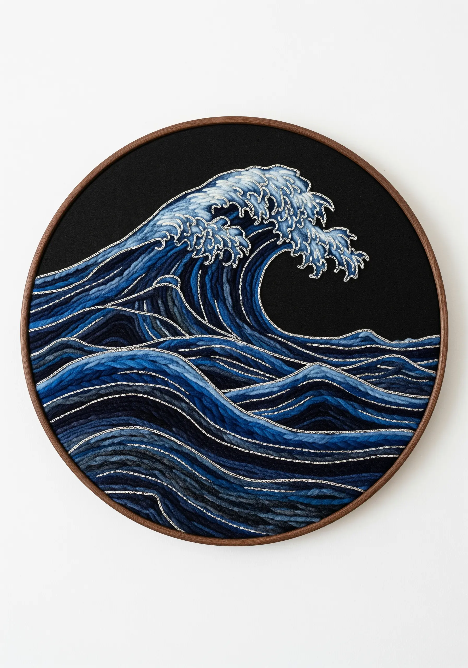 Stylized embroidery of ocean waves with blended blue fills and sharp white outlines.