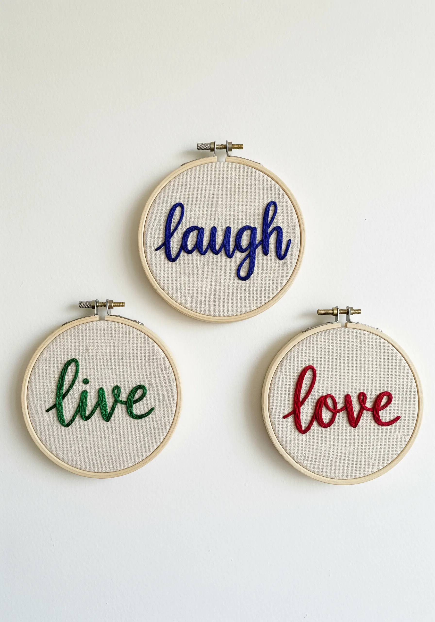 Trio of embroidery hoops with 'live,' 'laugh,' and 'love'