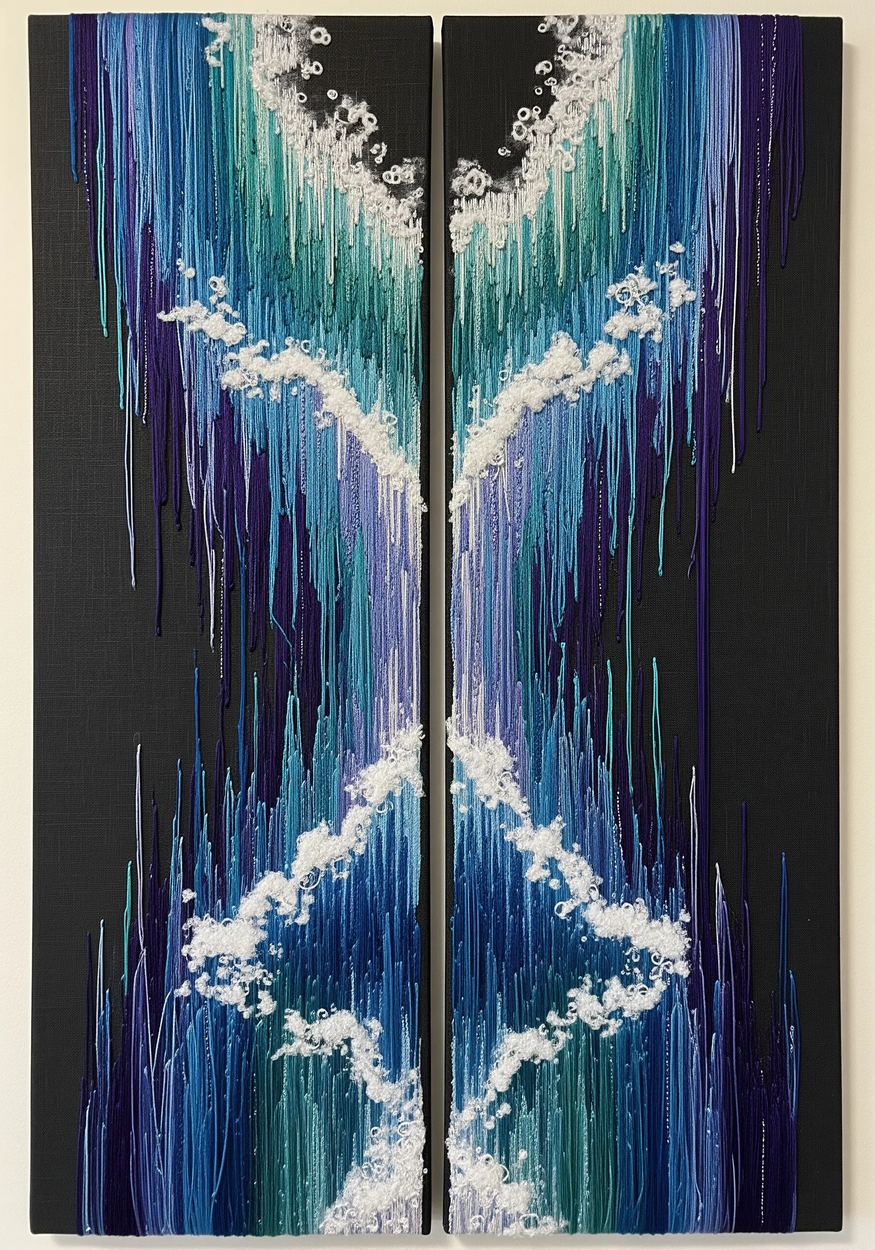 Diptych abstract embroidery with dripping blue threads and fluffy white fiber clouds.