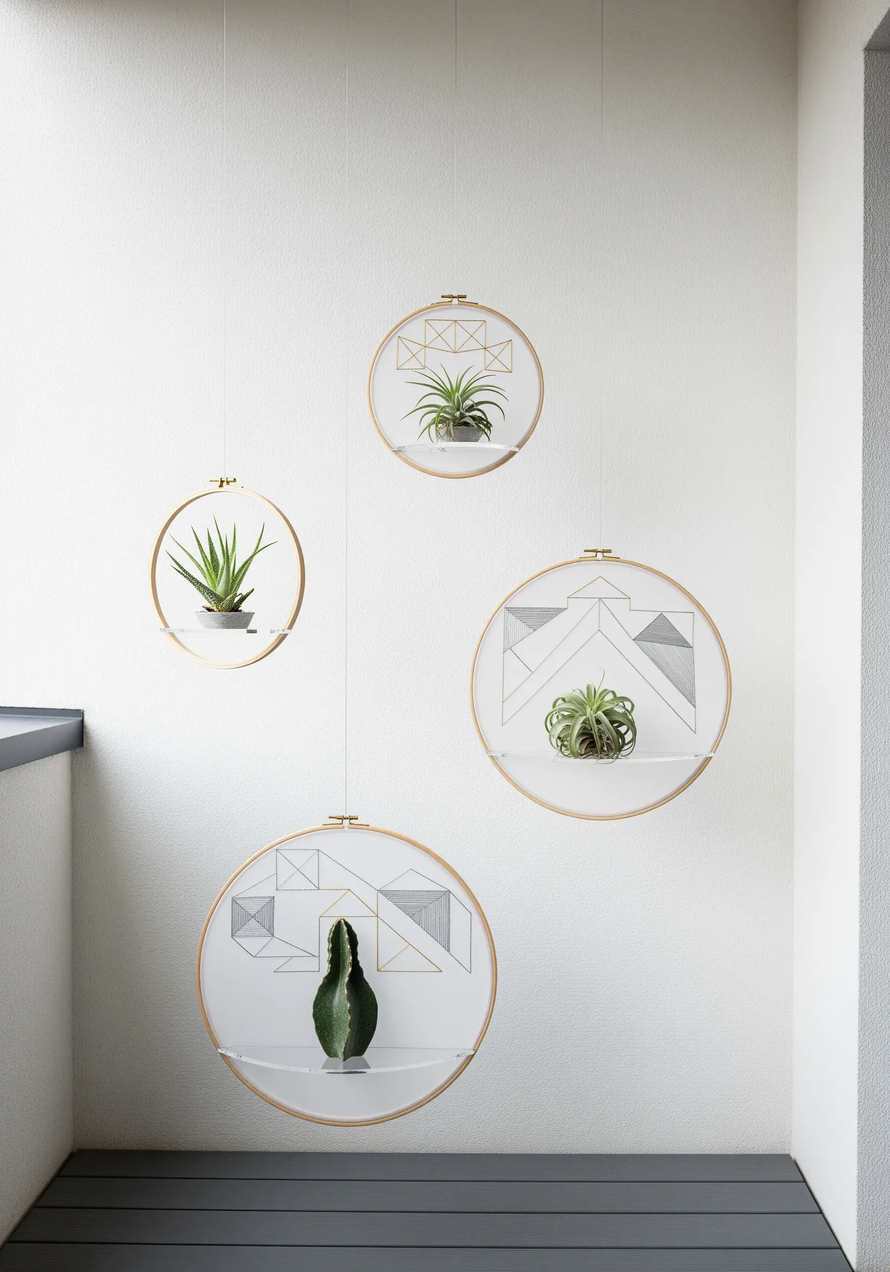 Minimalist geometric embroidery on hoops with clear acrylic shelves holding small plants.