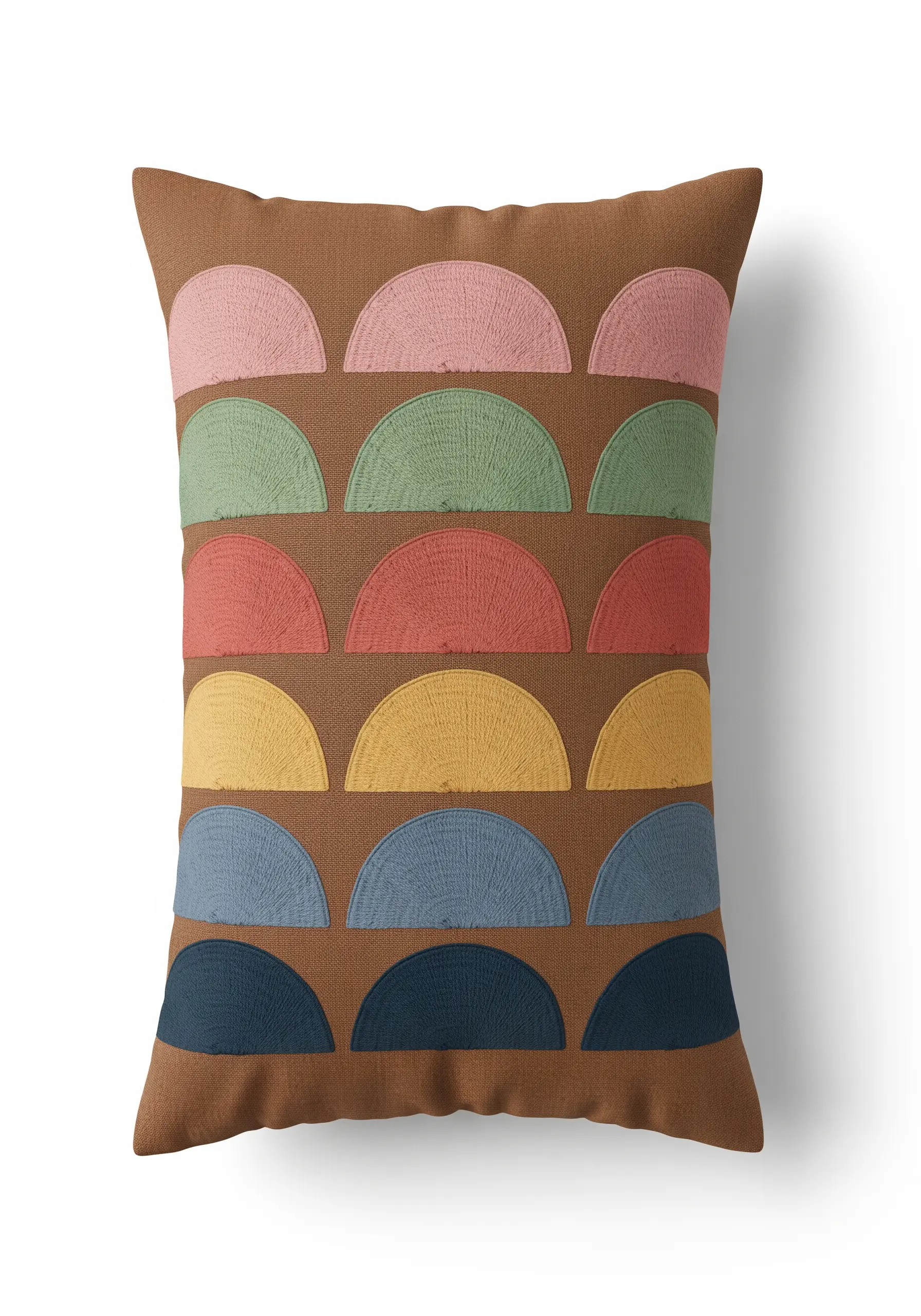 Rows of embroidered semi-circles in muted retro colors on a brown pillow.