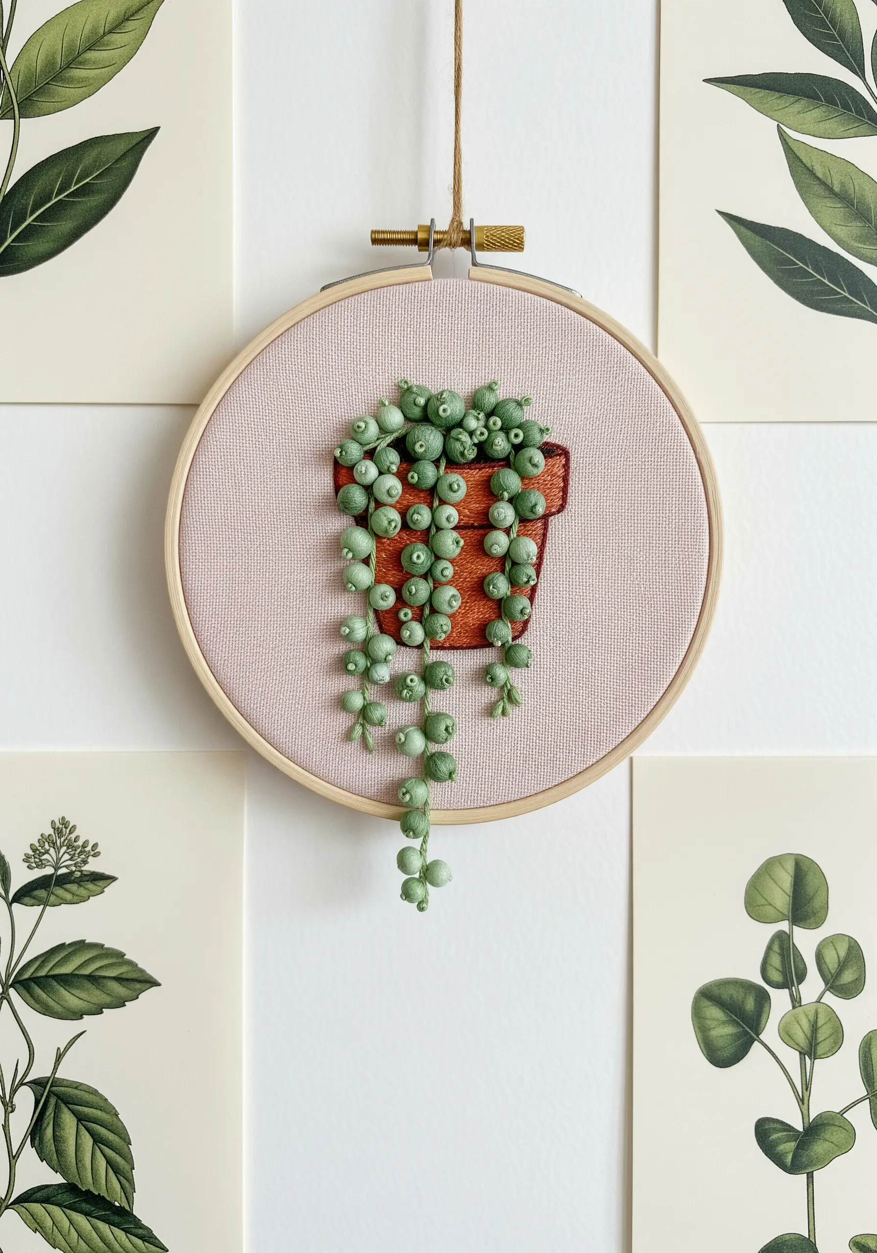 Embroidered String of Pearls plant with cascading green French knots in a terracotta pot.