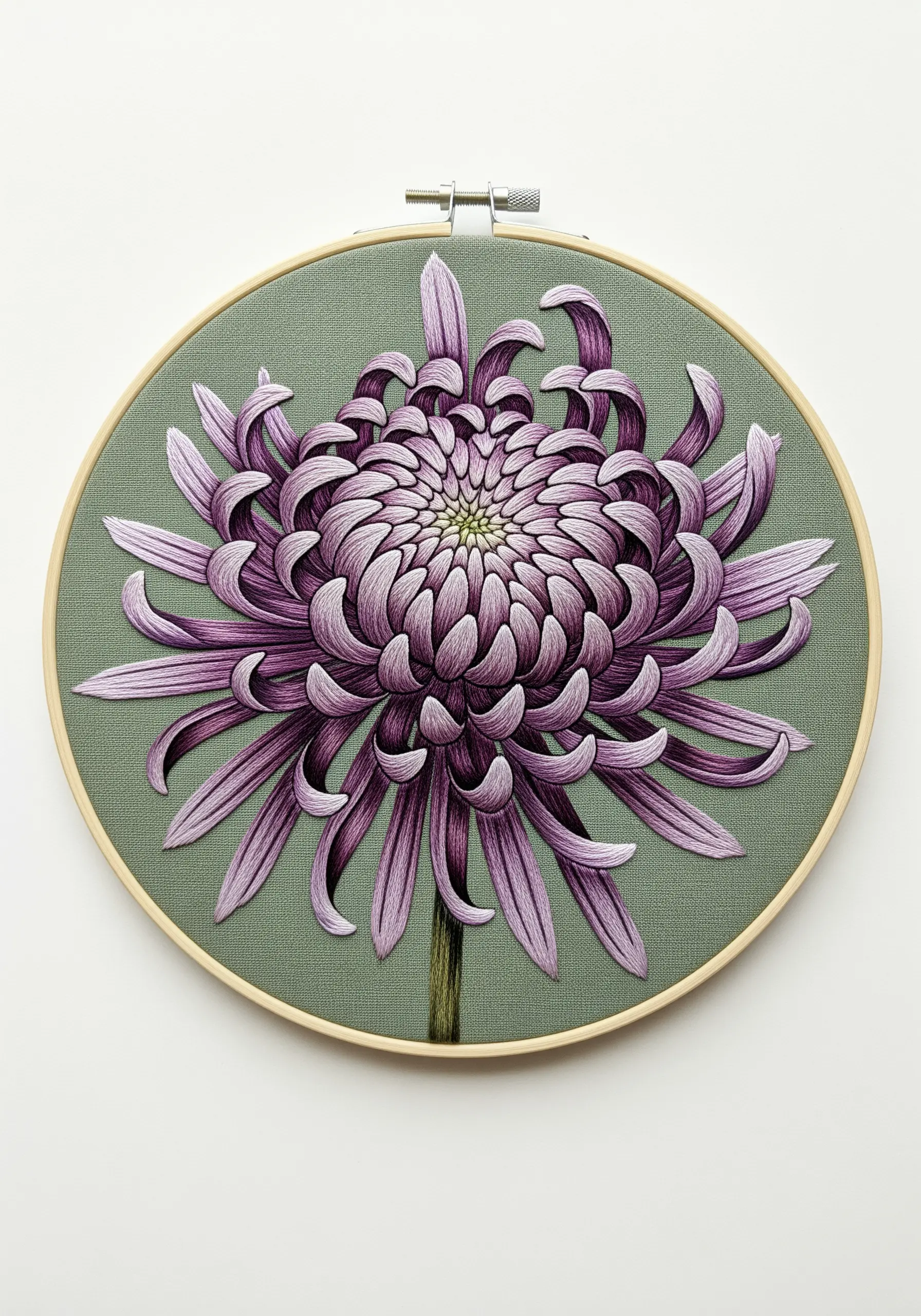 A detailed purple chrysanthemum with long, curving petals embroidered on a sage green background.