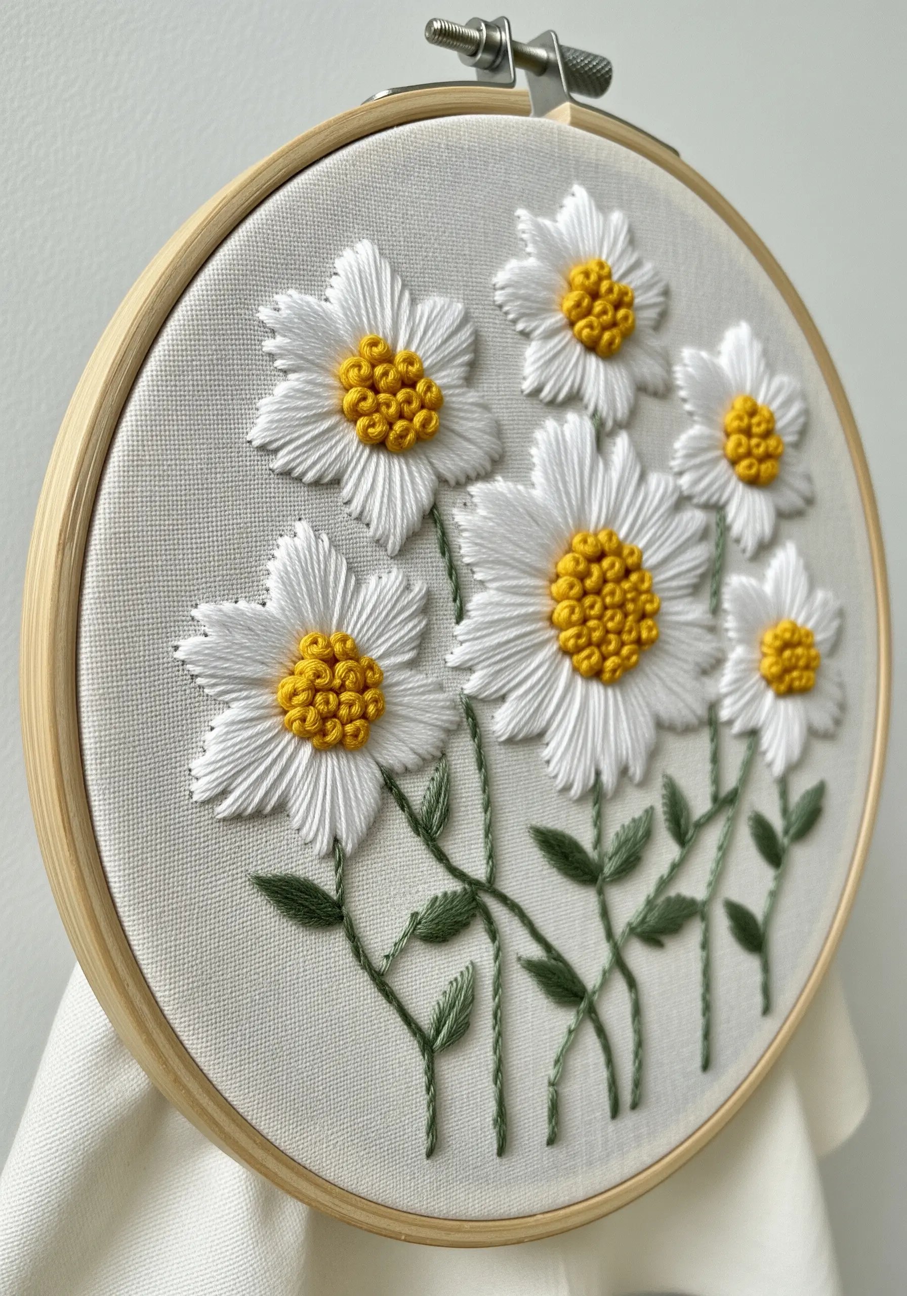 Embroidered white daisies with raised yellow French knot centers and smooth satin stitch petals.