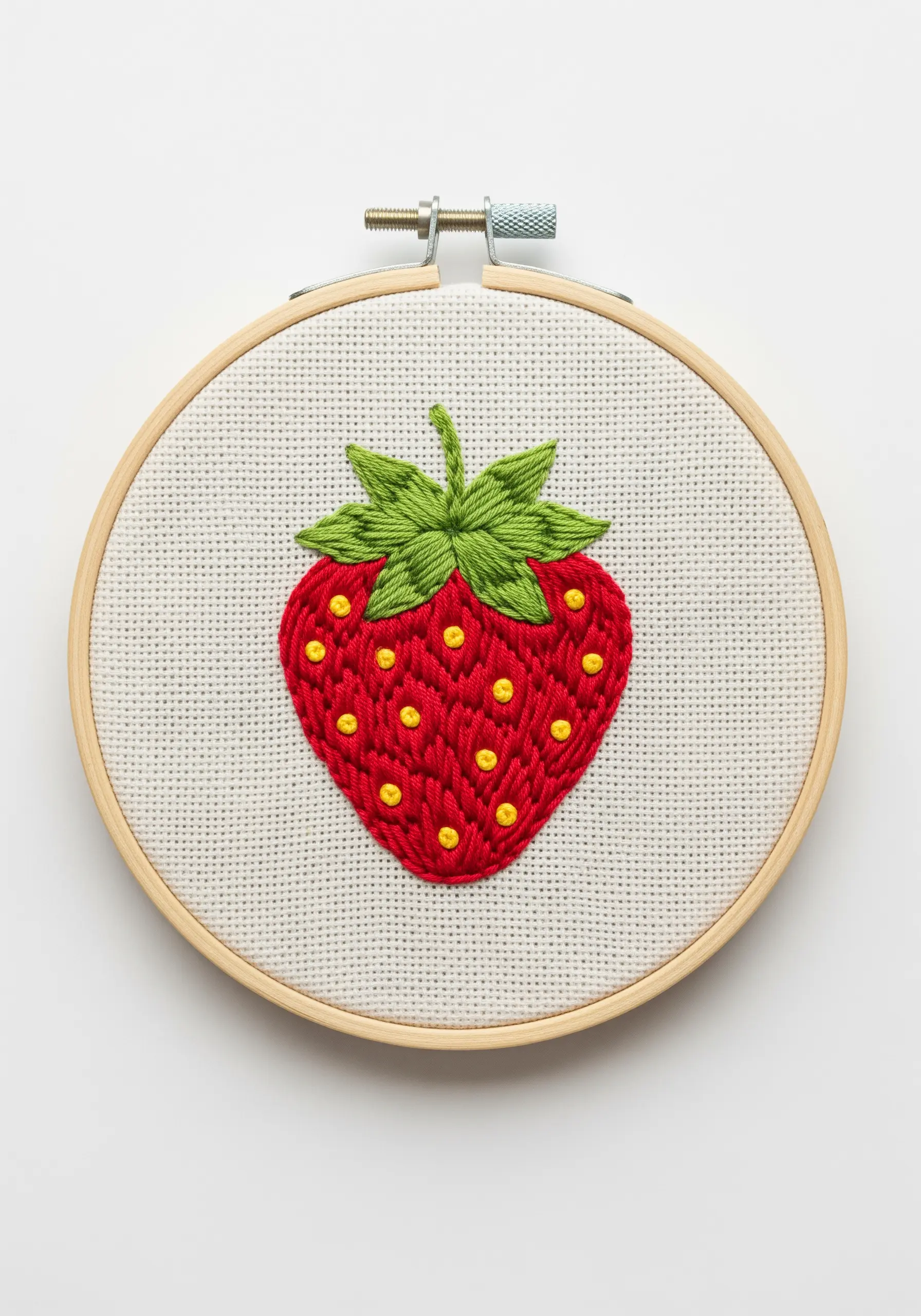 Embroidered strawberry with red satin stitch and raised yellow French knot seeds.