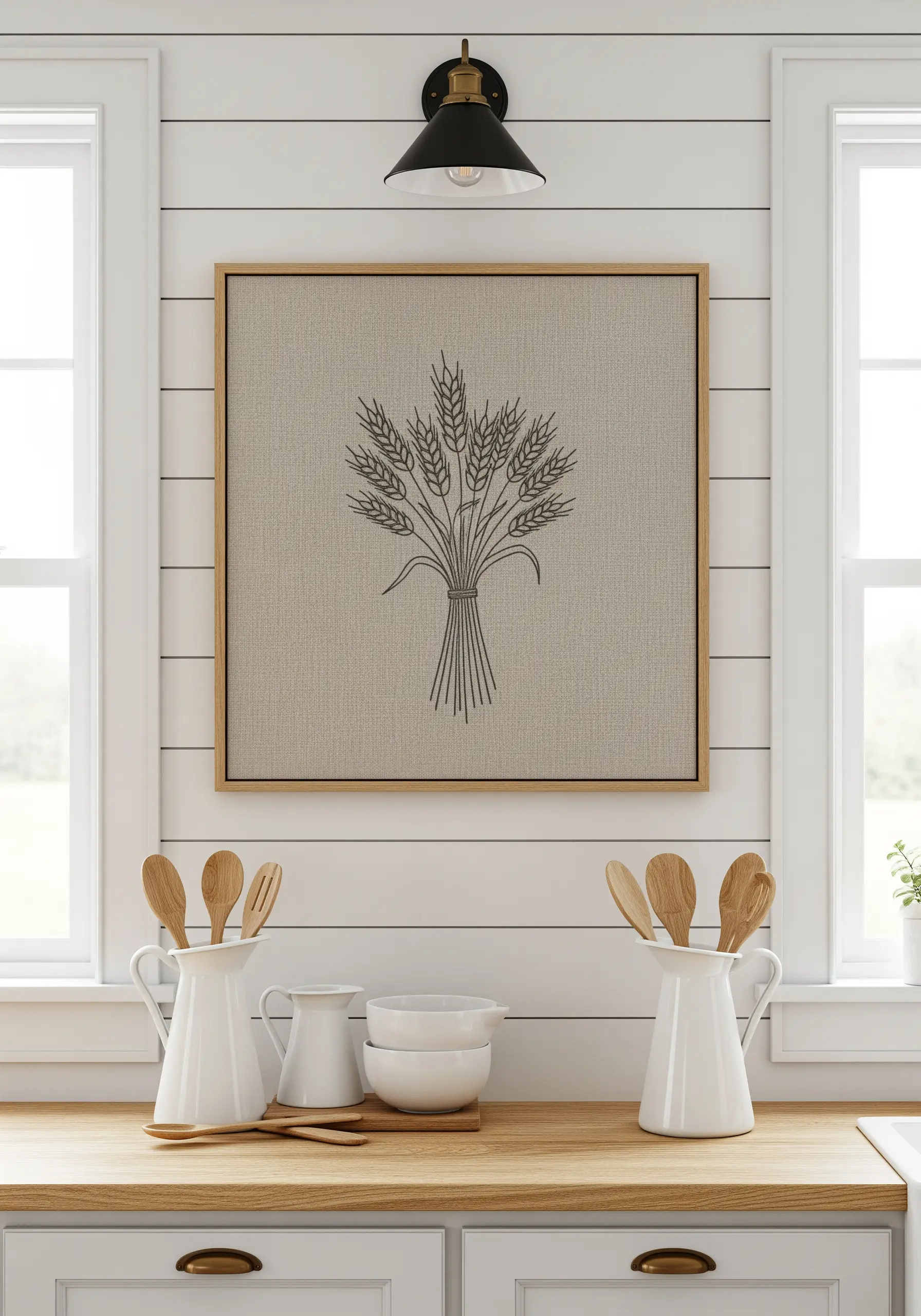 A simple line art embroidery of a wheat sheaf on oatmeal linen fabric.