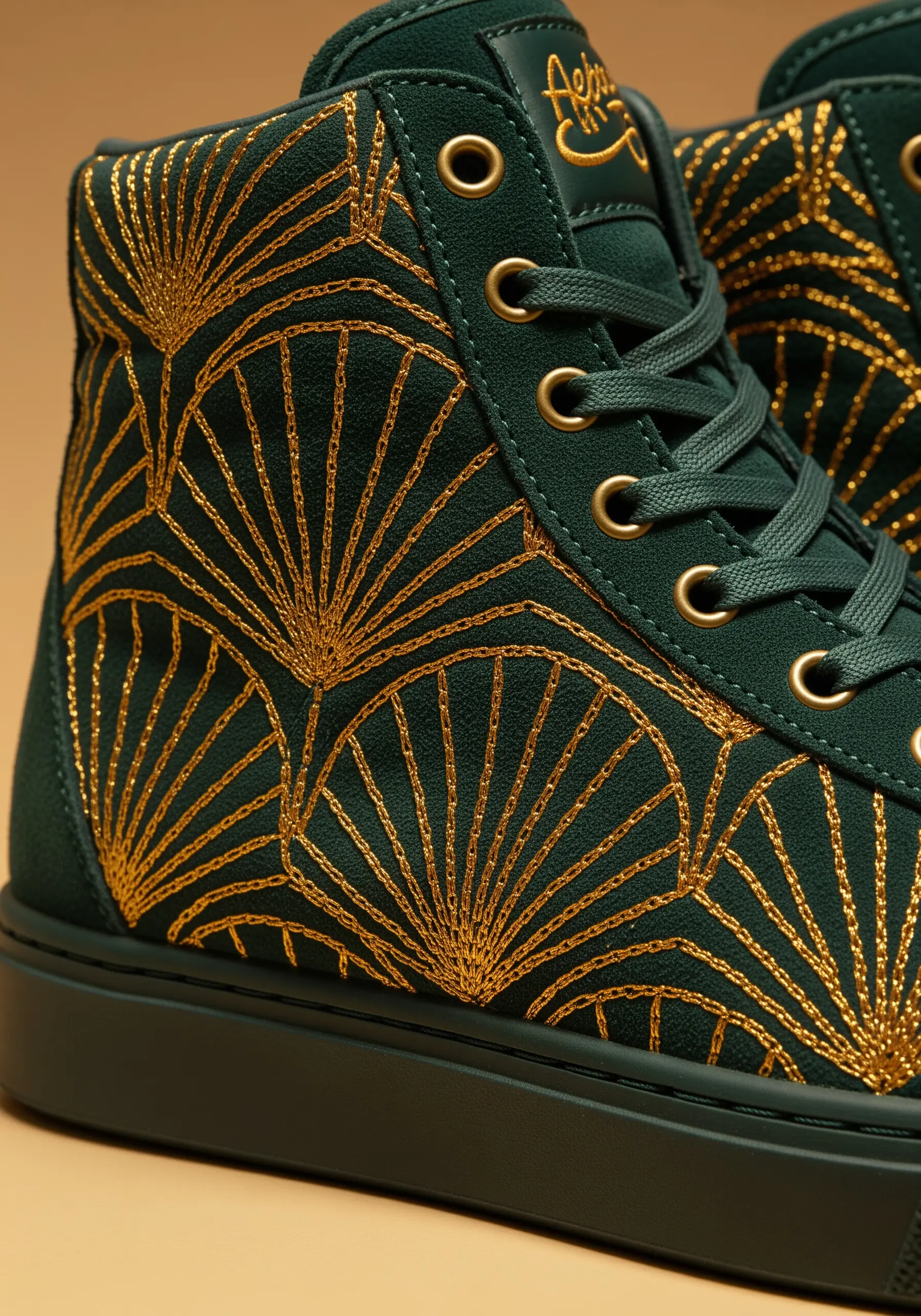 Gold metallic thread in an Art Deco fan pattern embroidered on dark green high-top sneakers.