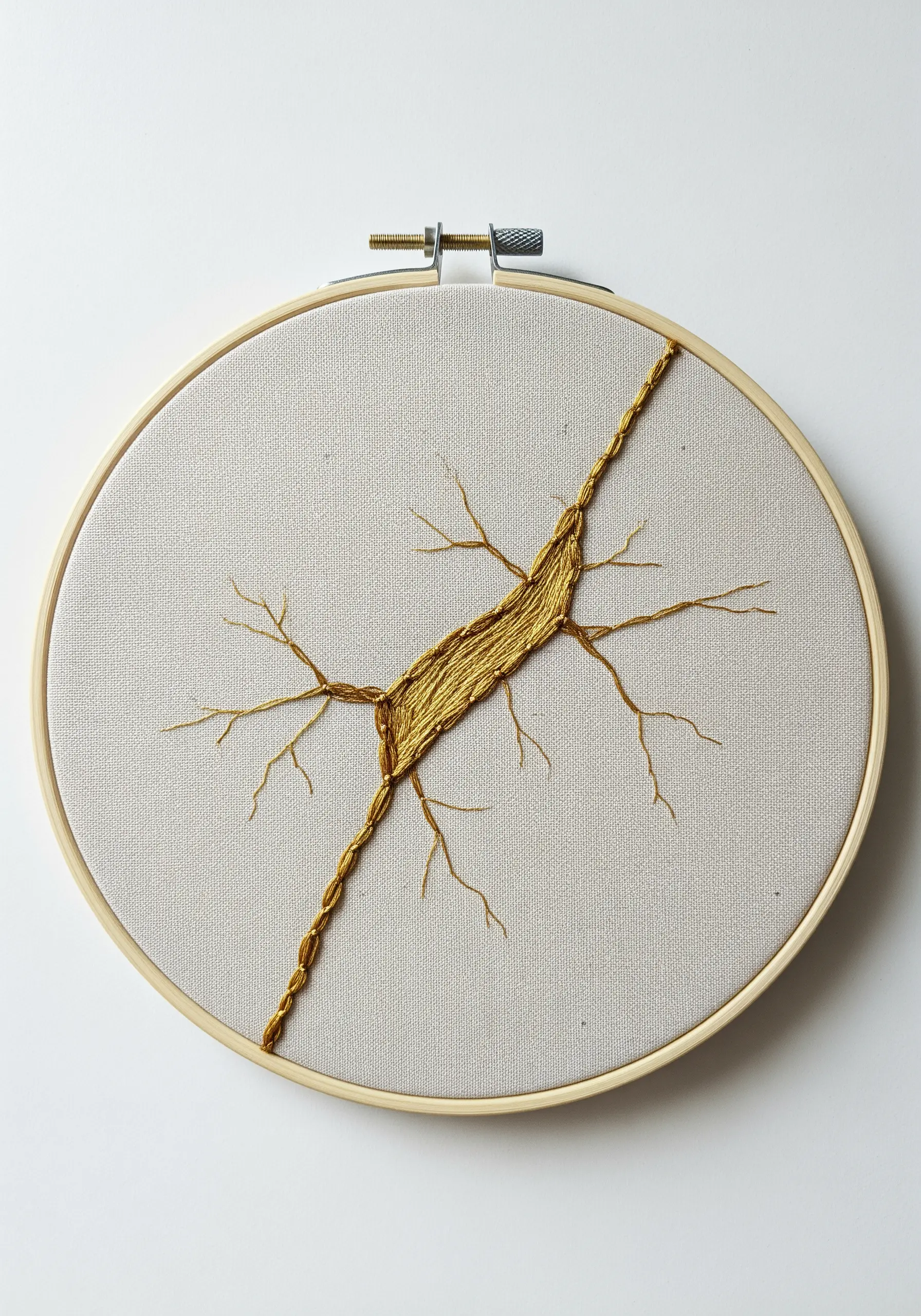 A crack in the fabric 'mended' with gold metallic thread, inspired by Kintsugi.