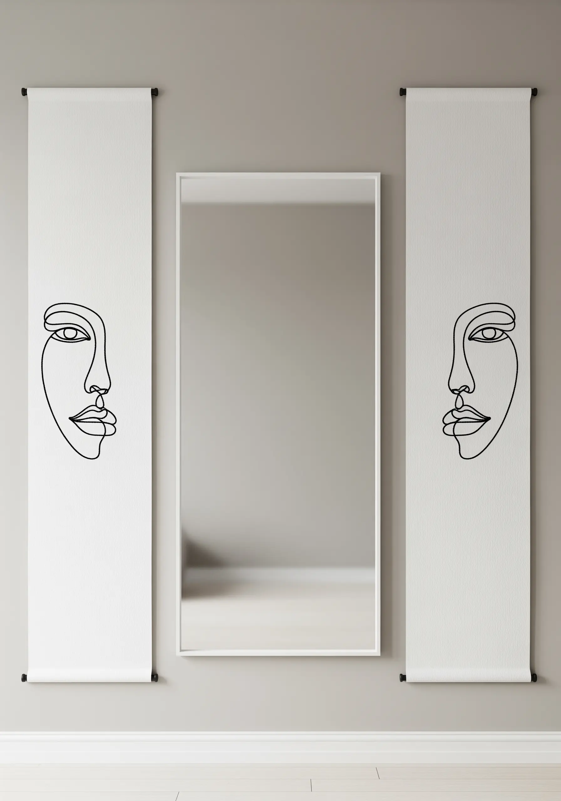 Two vertical banners with minimalist, single-line embroidered faces flanking a mirror.