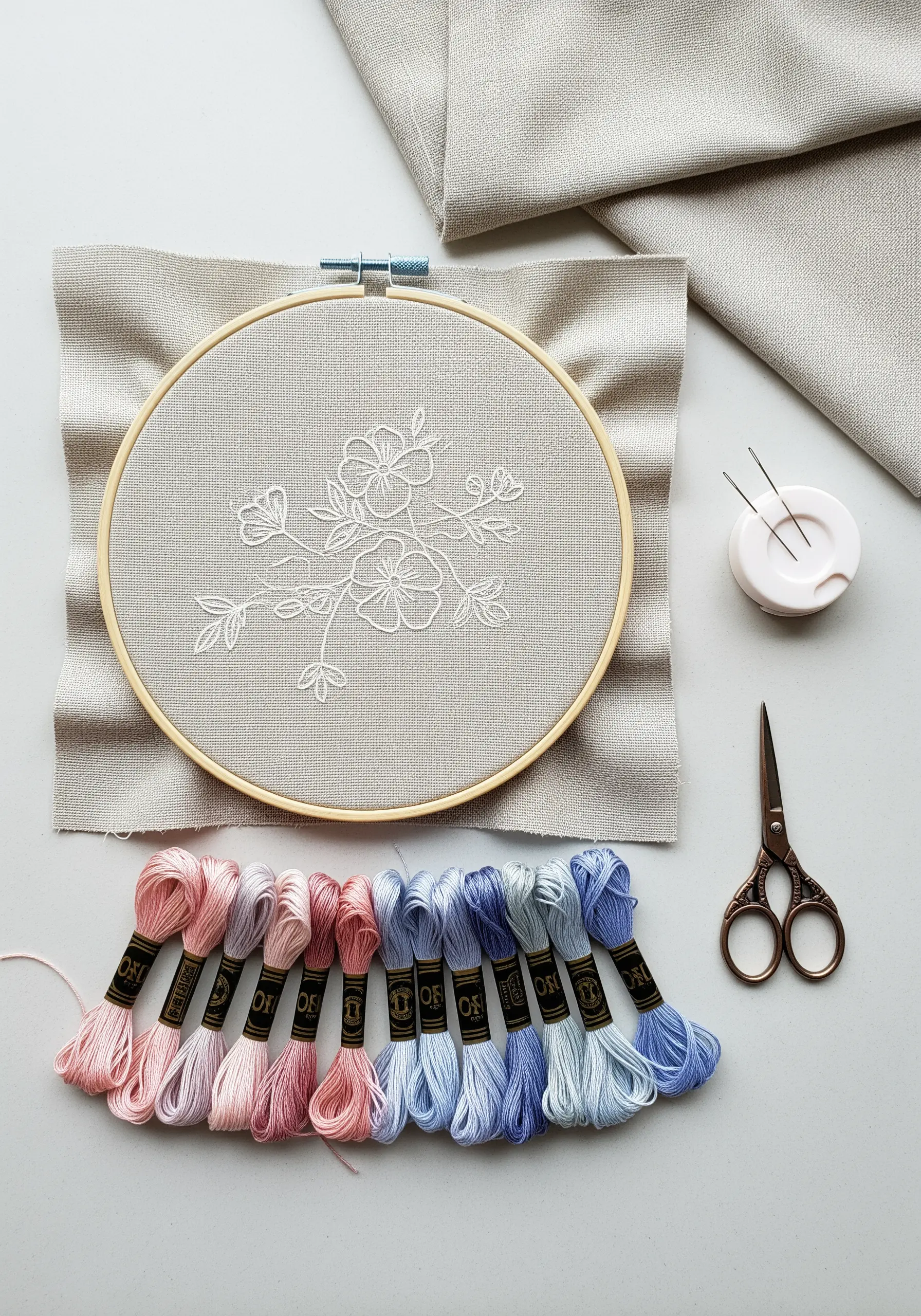 A simple floral line art design stitched in white thread on beige linen fabric.